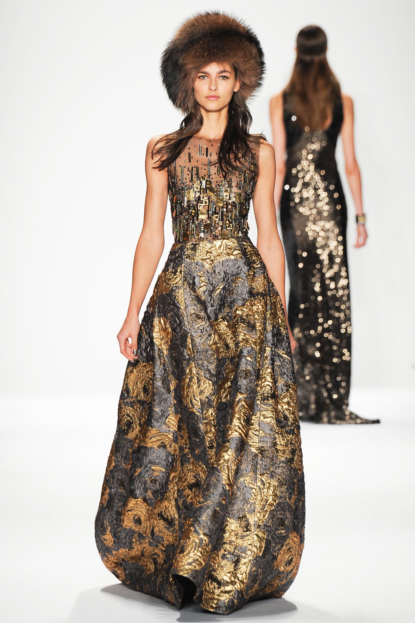 gold and black embellished gown with fur hat