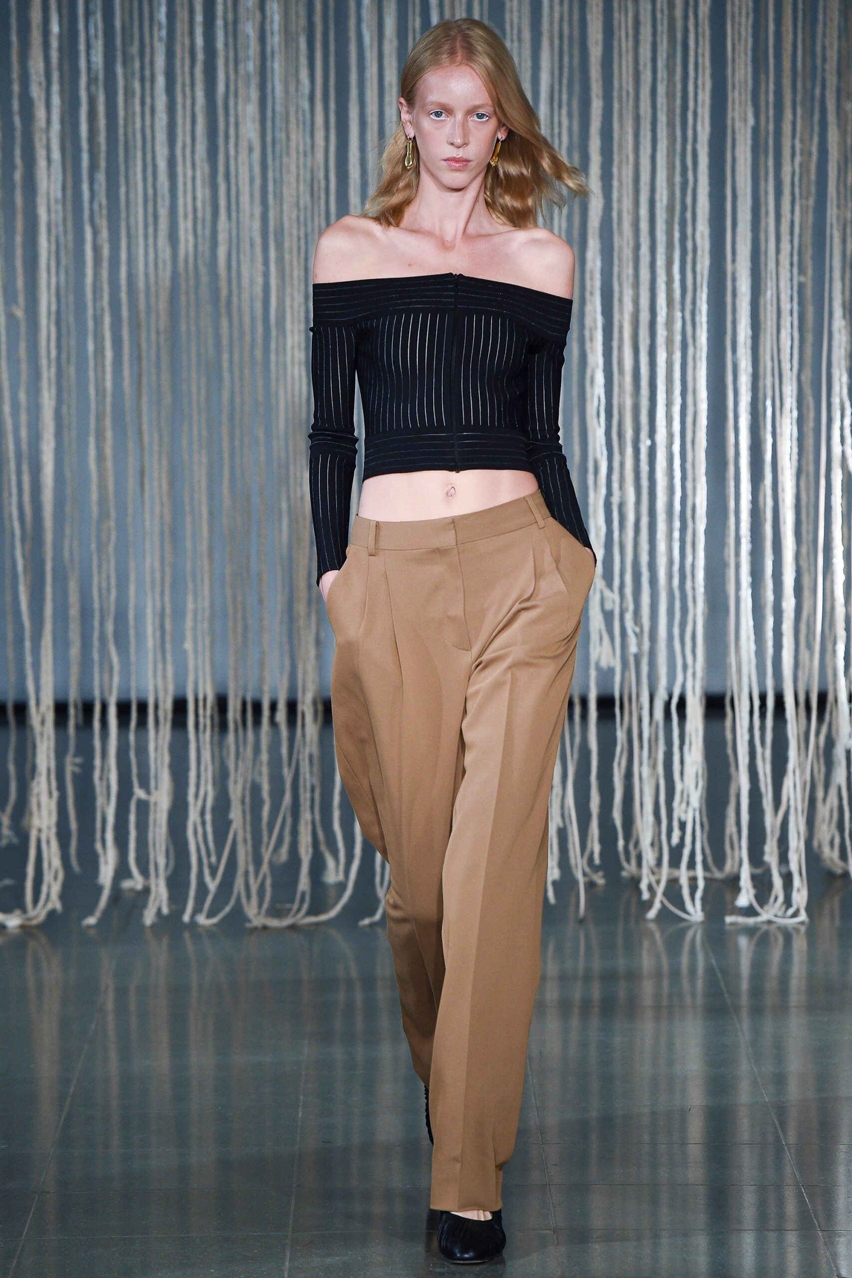 black off-shoulder top and beige pants