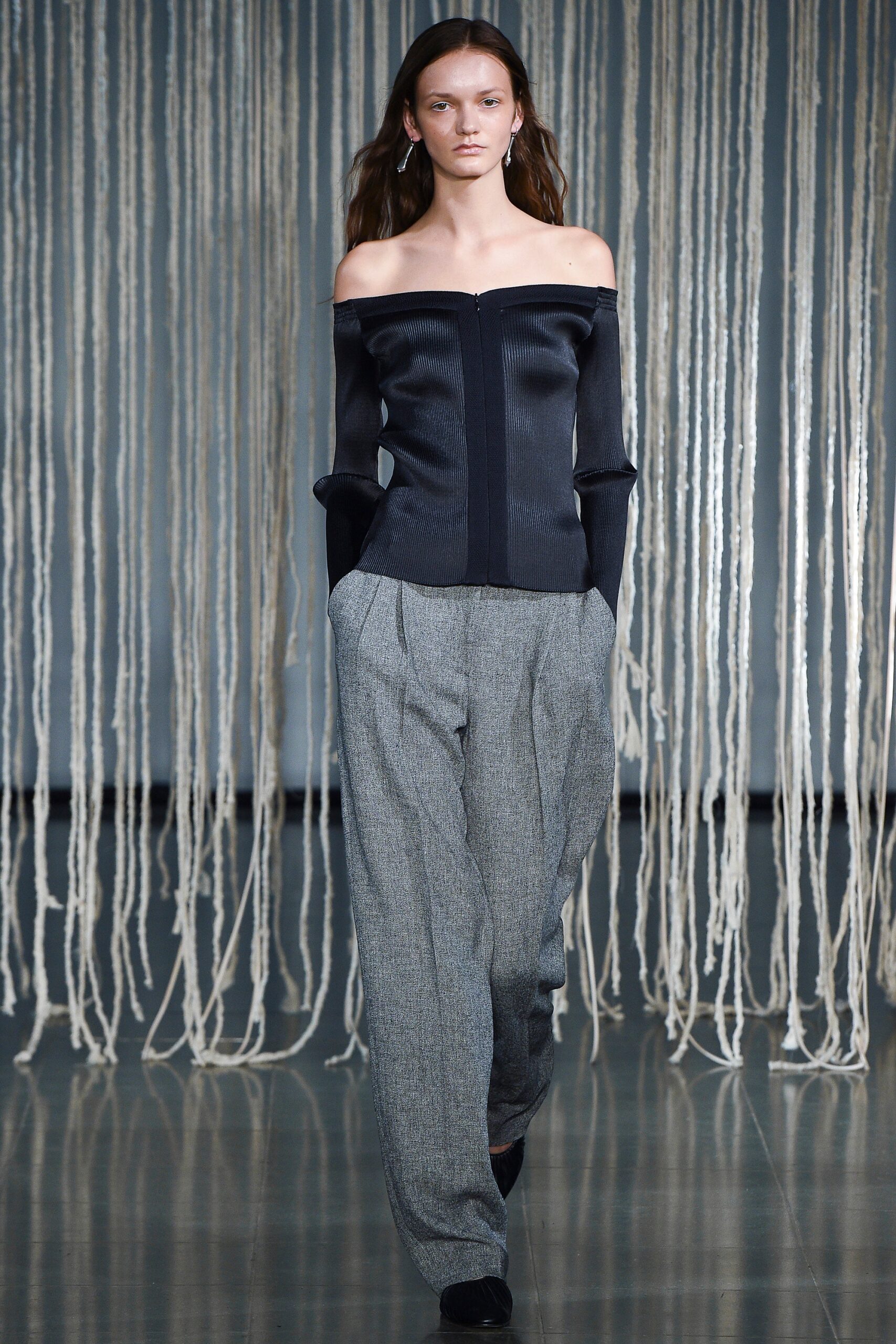 black off-shoulder top with gray pants
