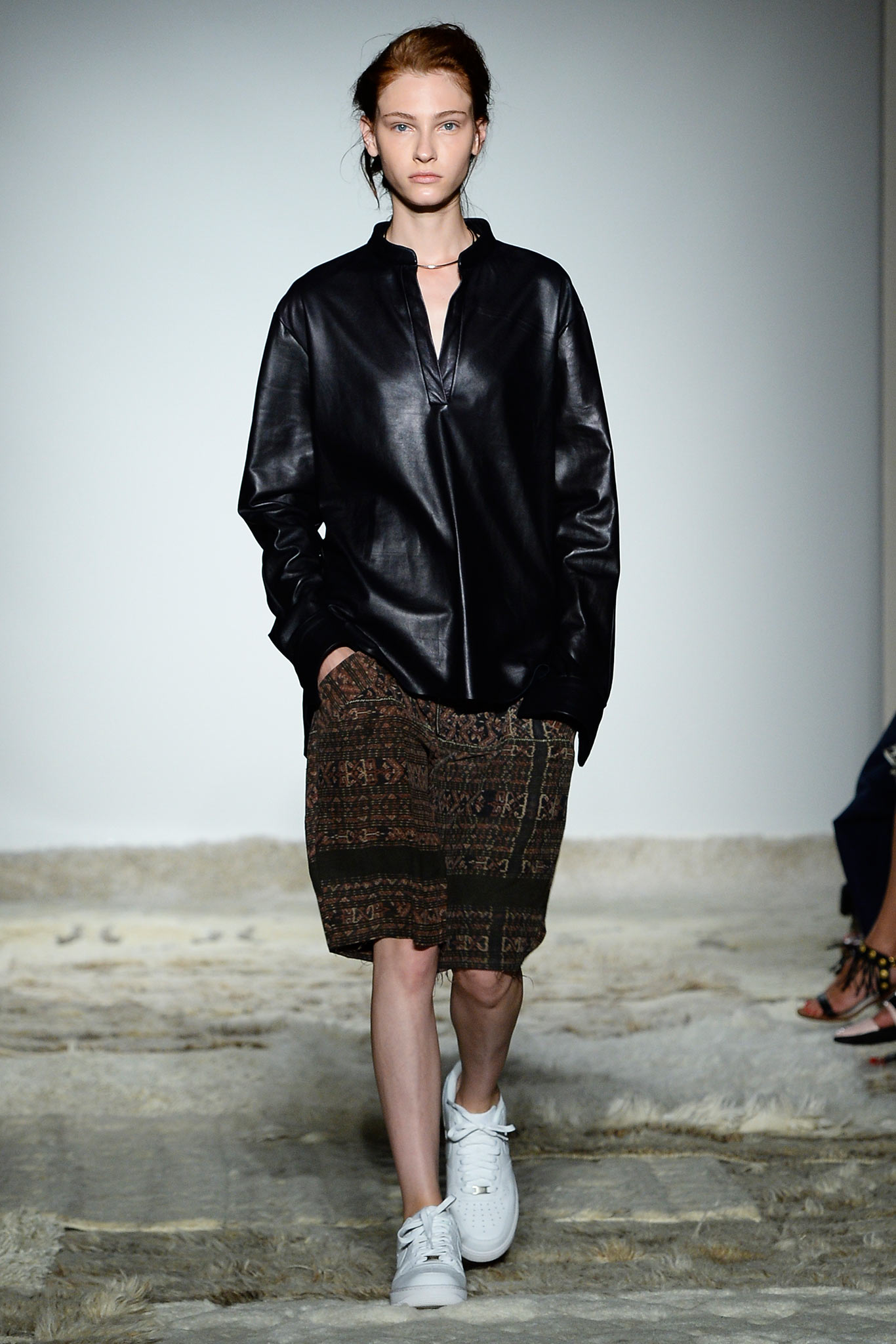 black leather shirt with brown shorts