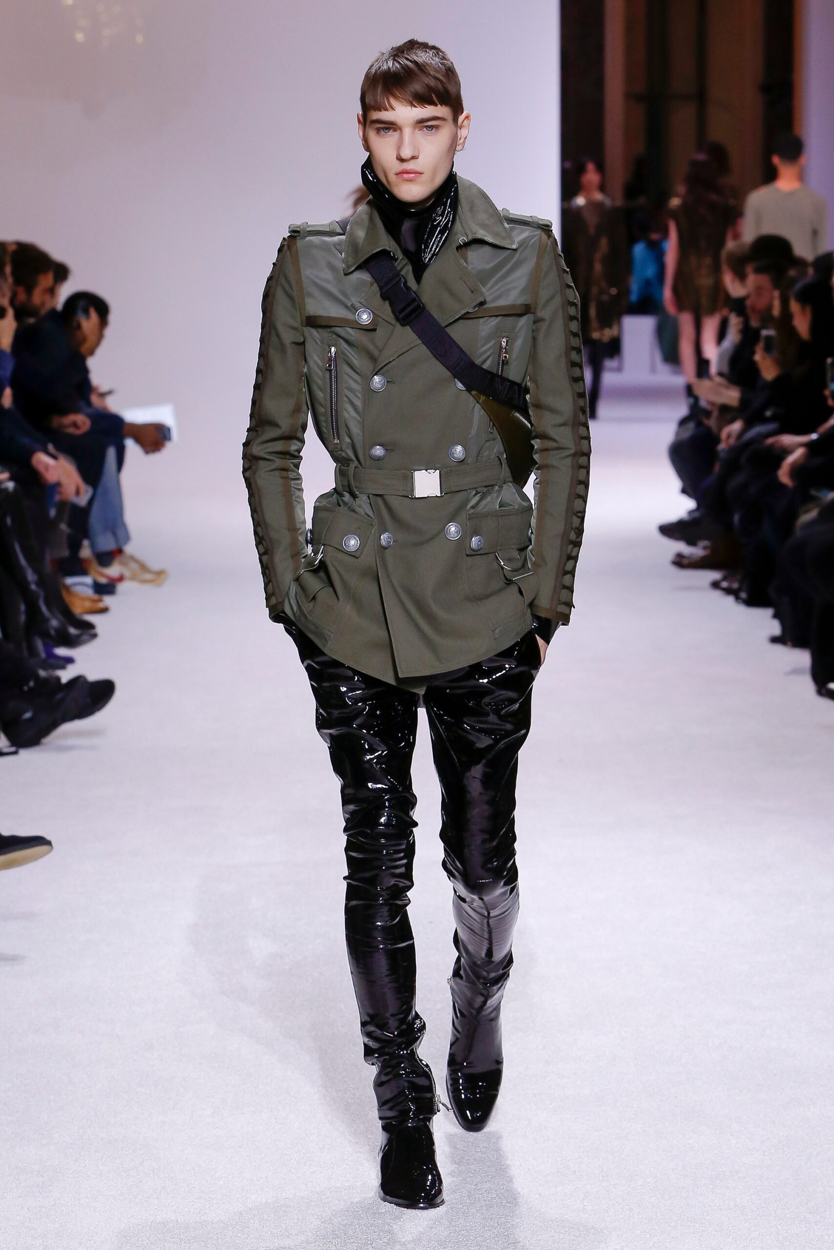 green fitted jacket with black pants