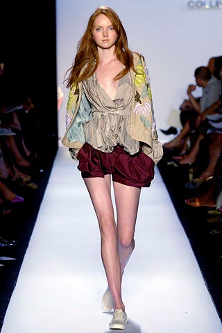 beige silk ruffled blouse and maroon shorts