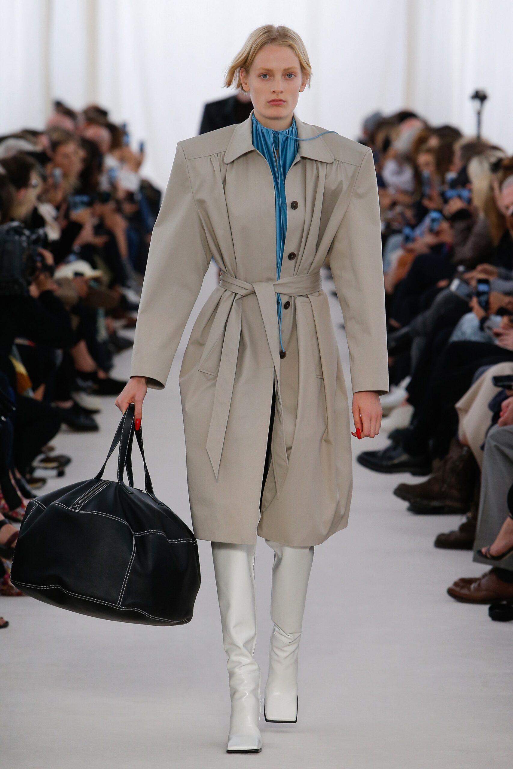 beige coat with blue top and white boots