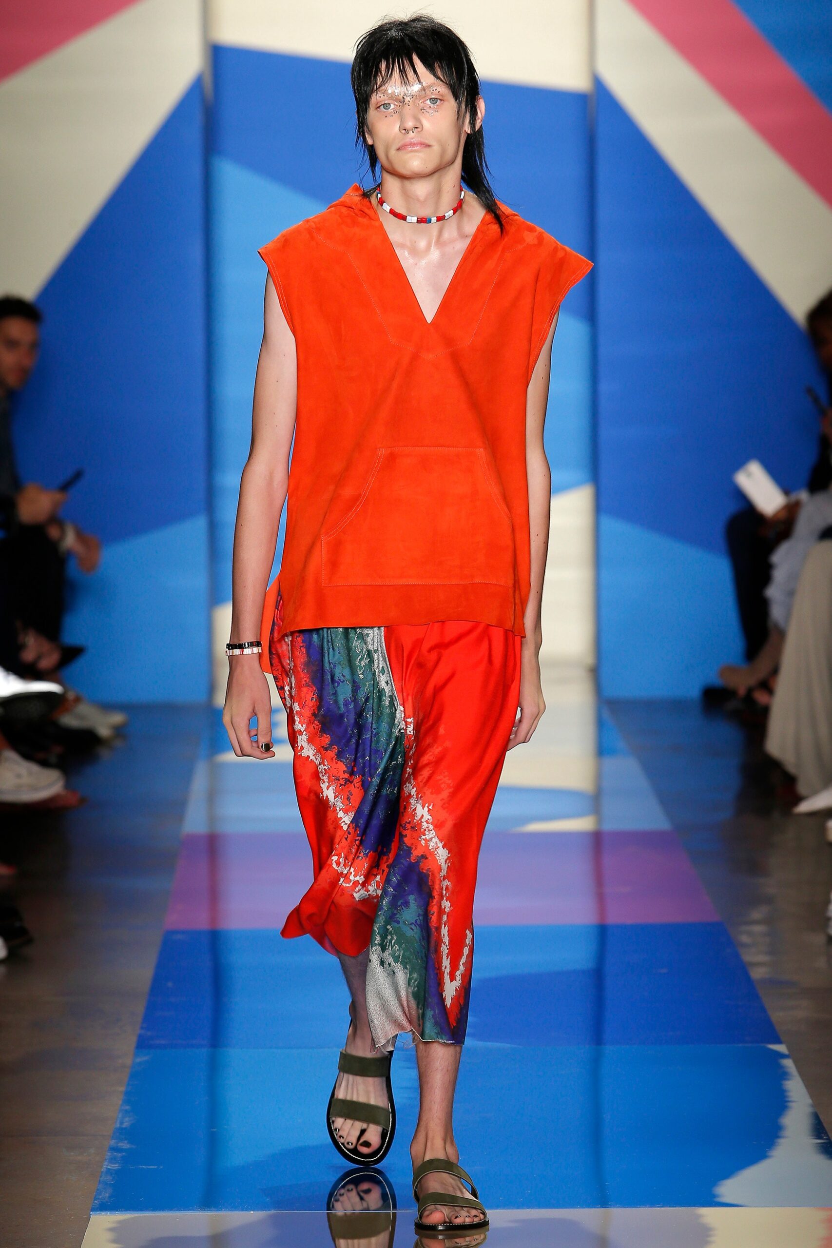 orange suede sleeveless top with red silk pants