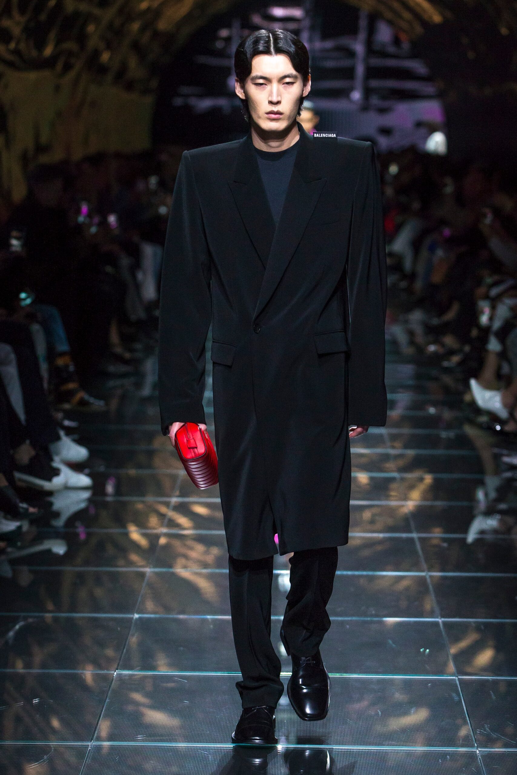 black tailored coat with red bag