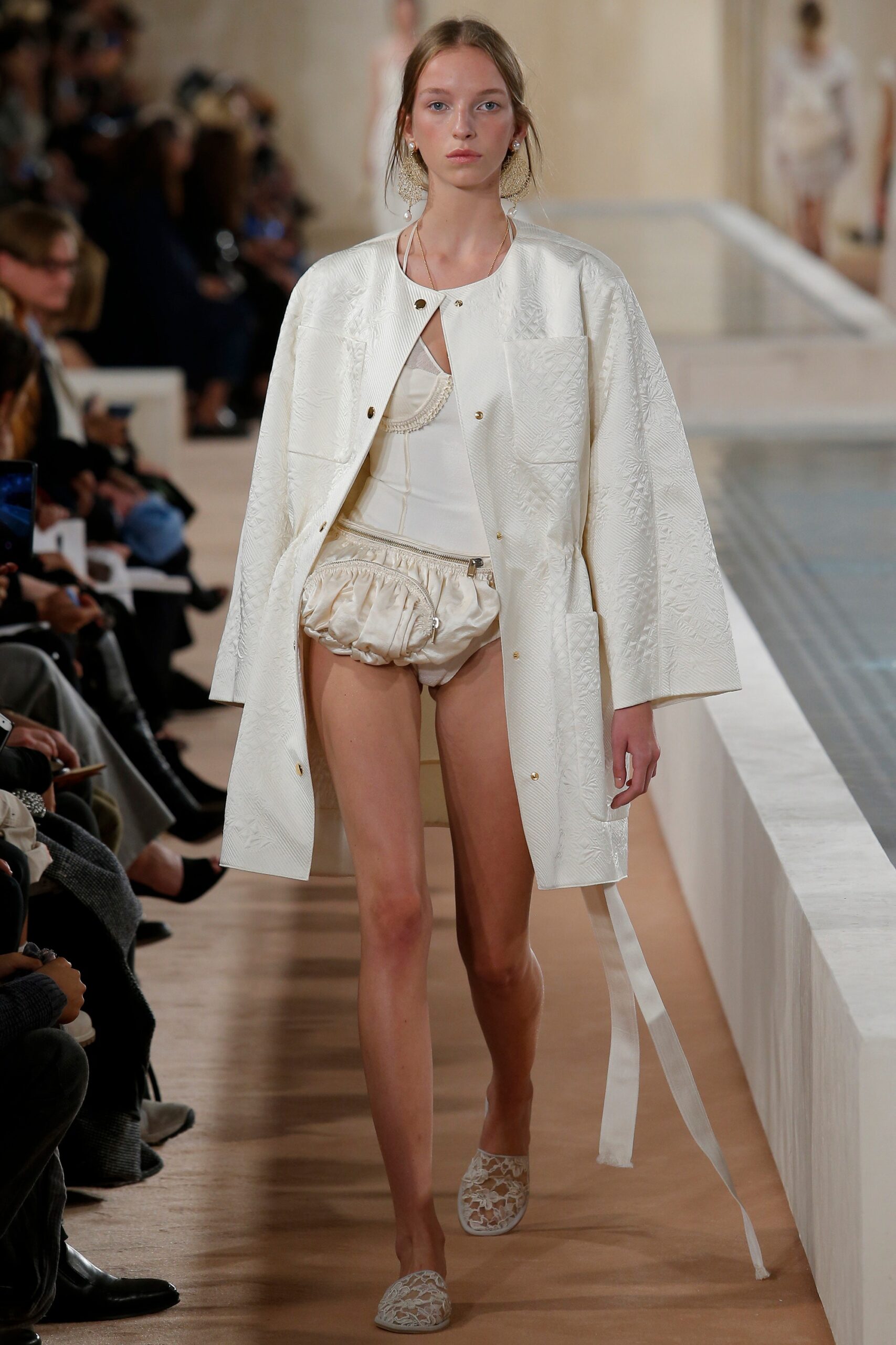 white relaxed coat with bodysuit and shorts