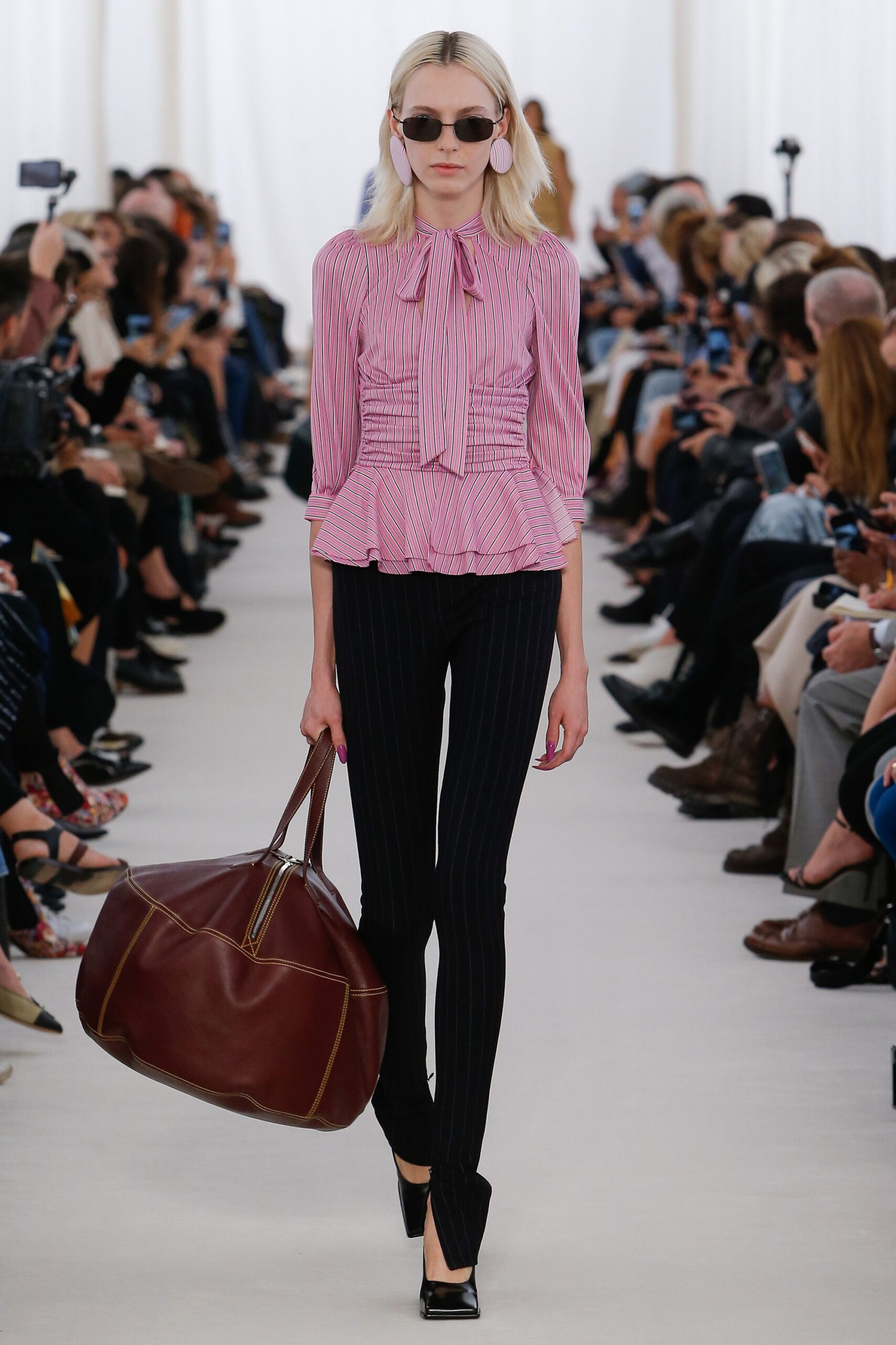 pink fitted blouse with striped pants