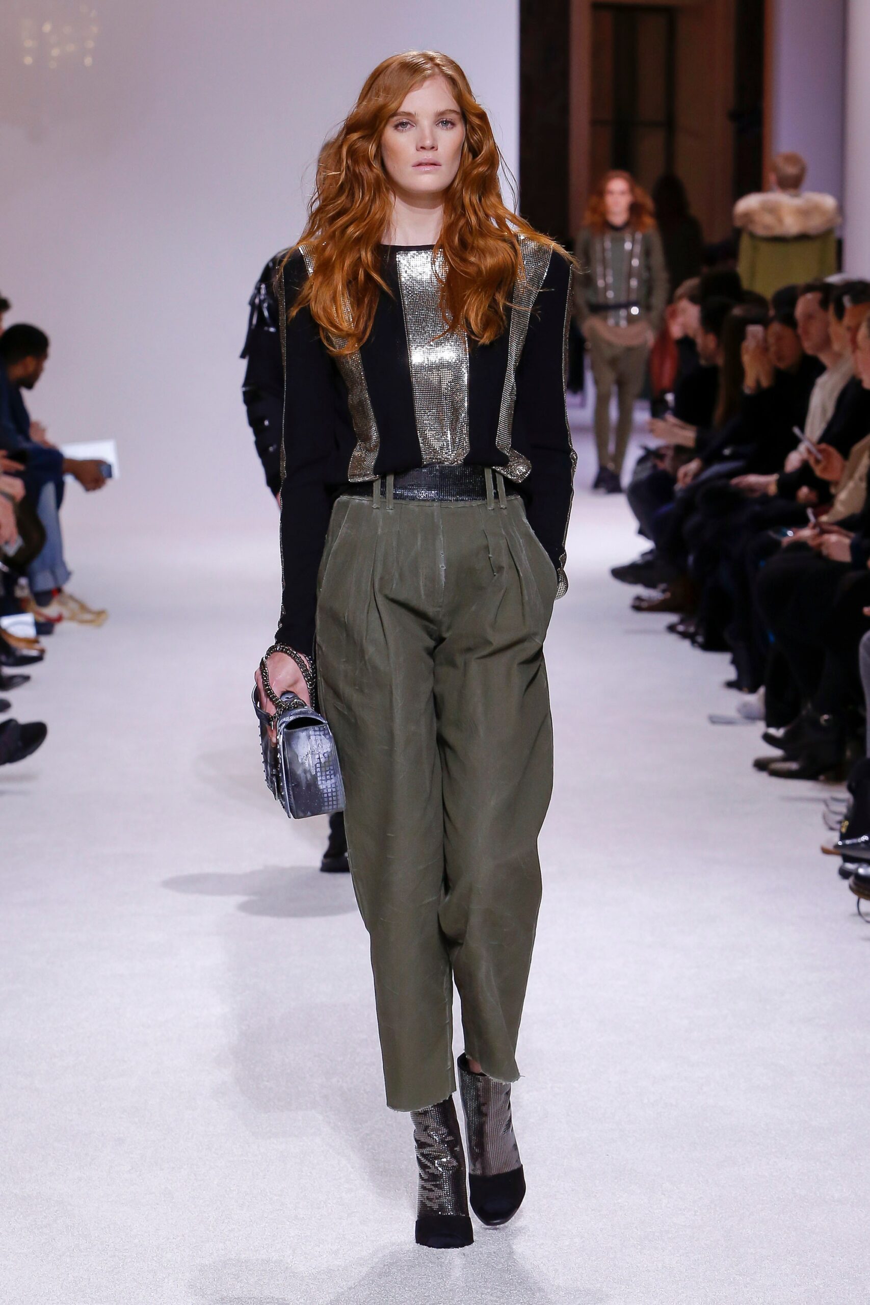 black fitted top with green pants