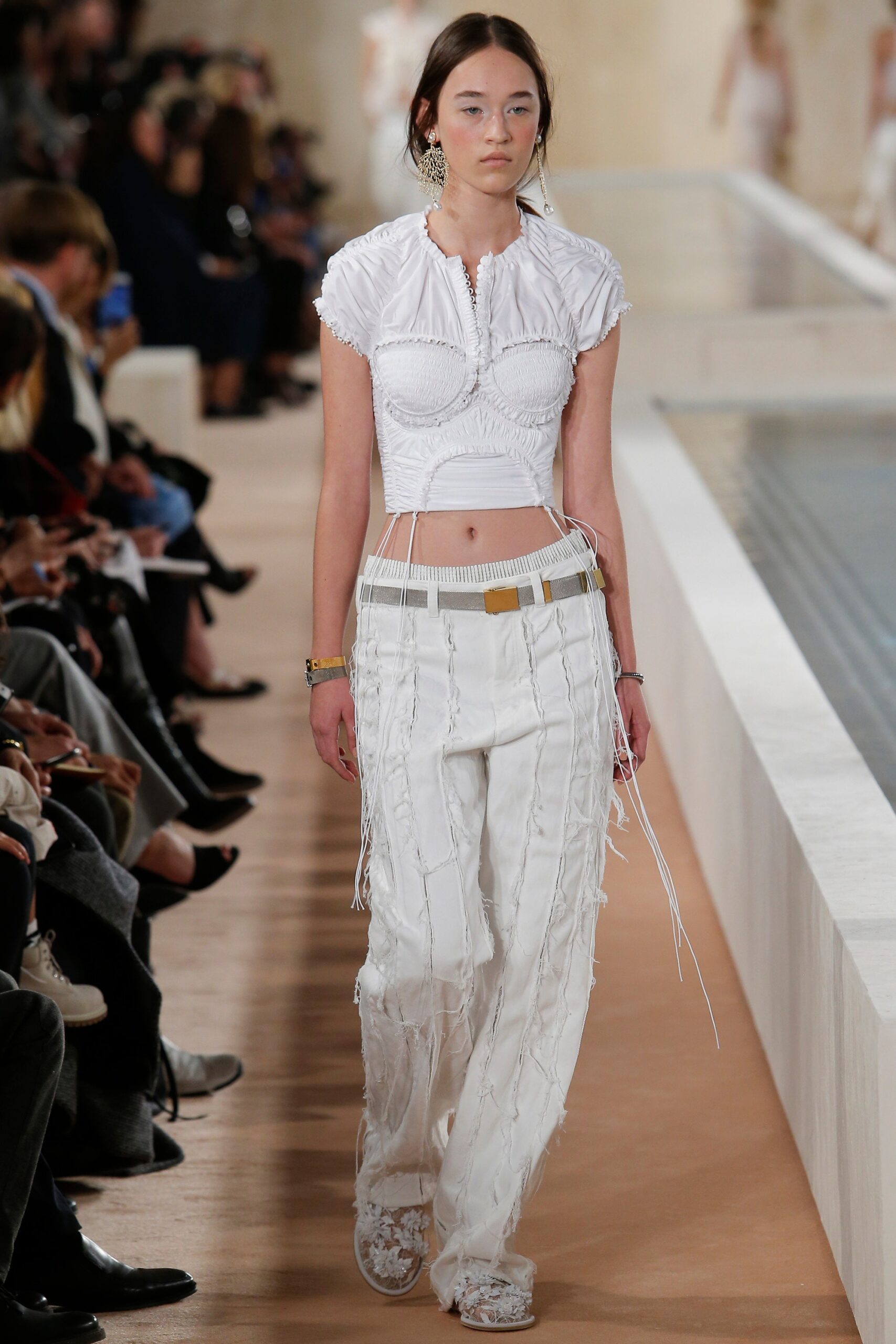white embroidered fitted top and relaxed pants