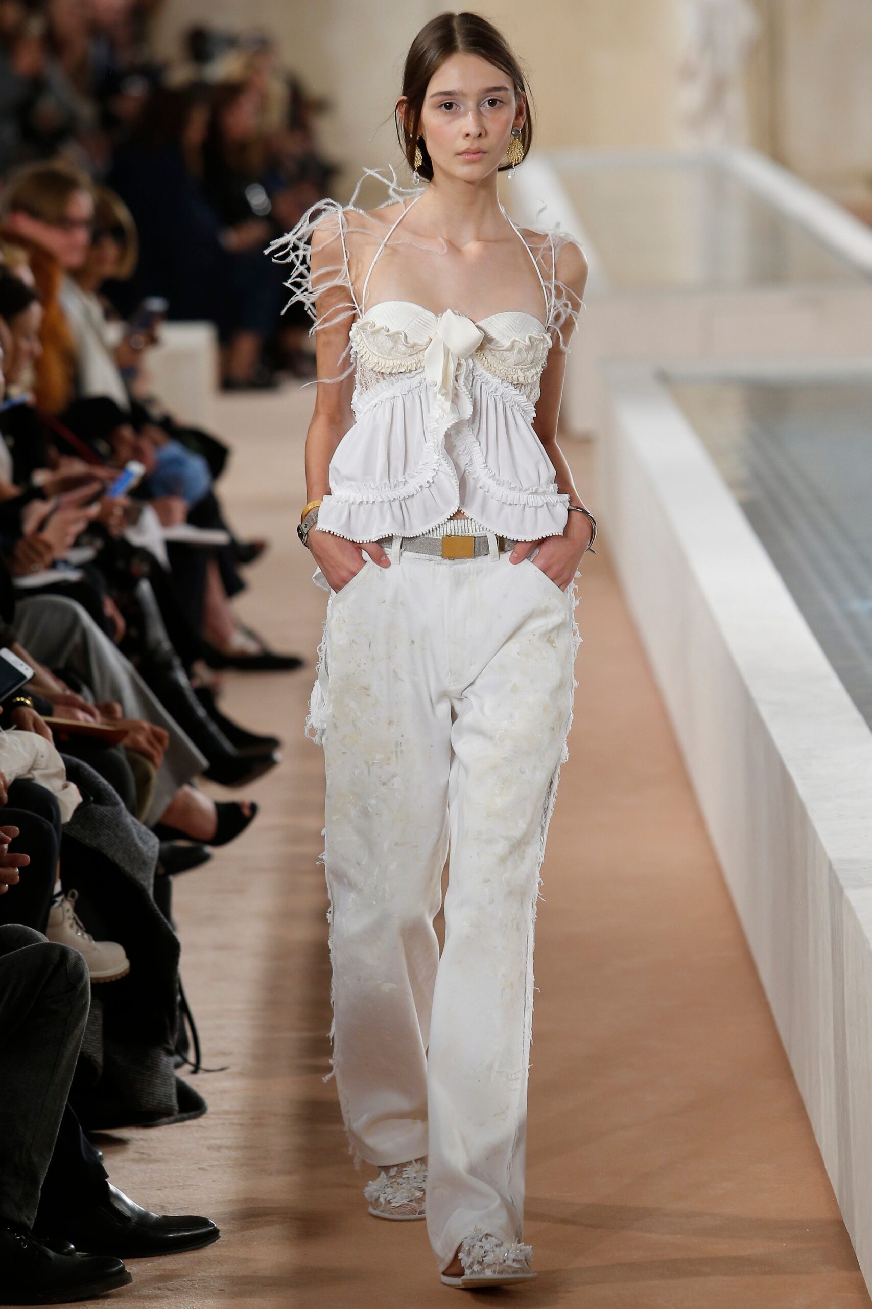 white ruffled top and relaxed pants