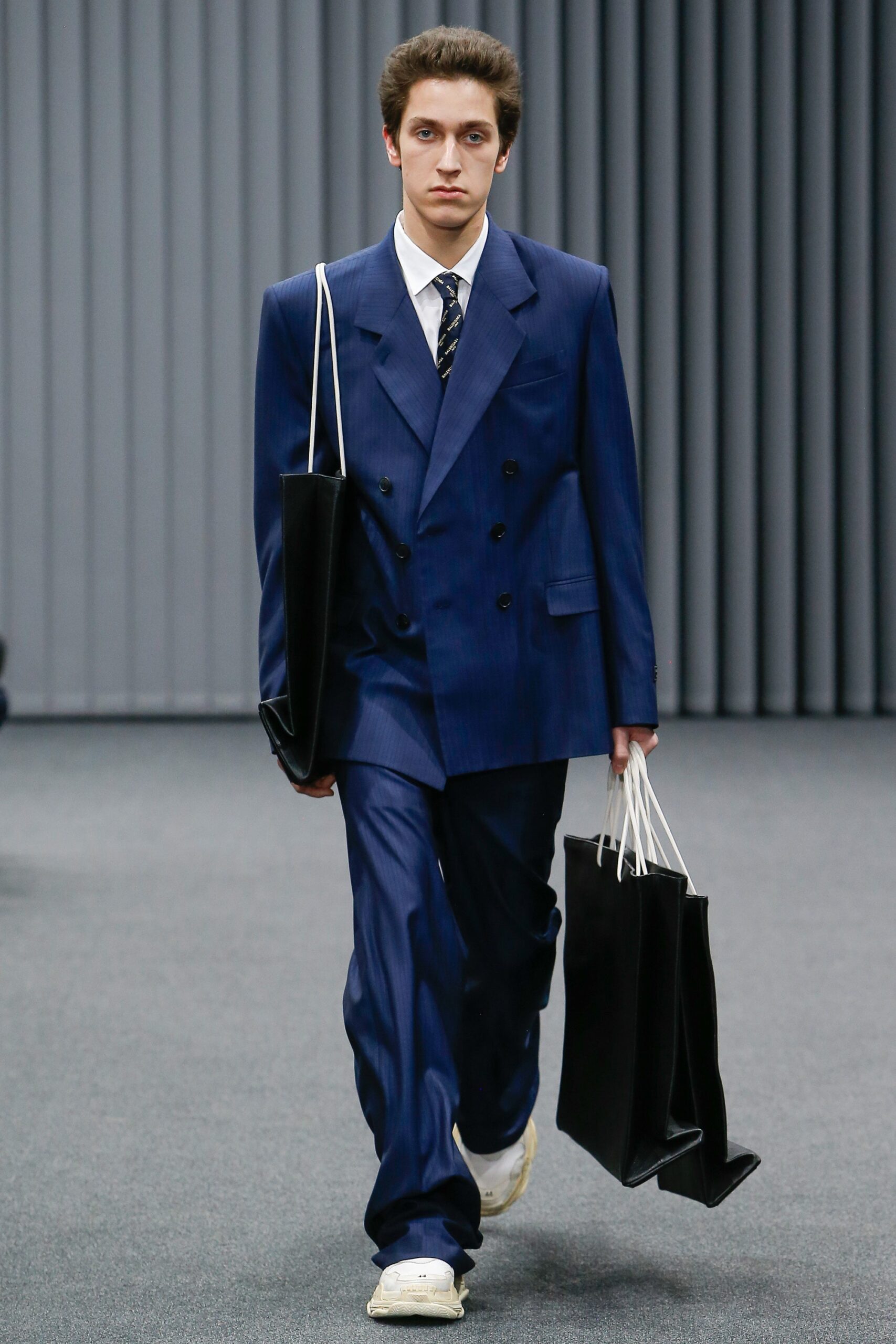 blue tailored suit with white shoes