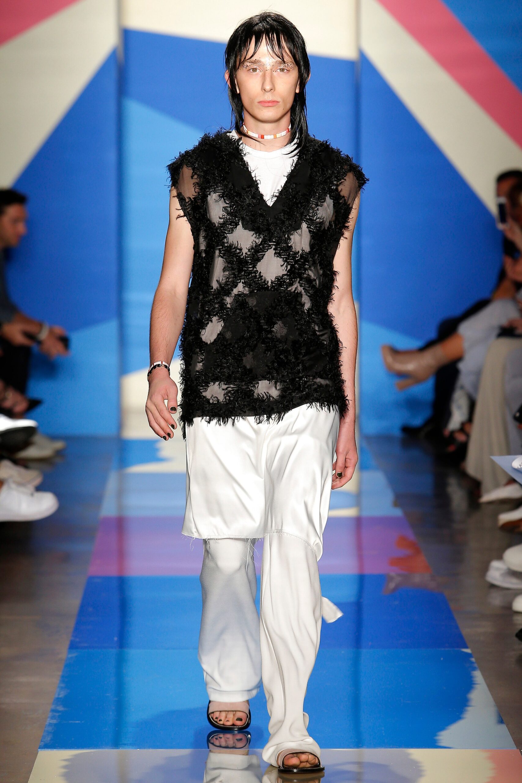 black fringed top with white pants