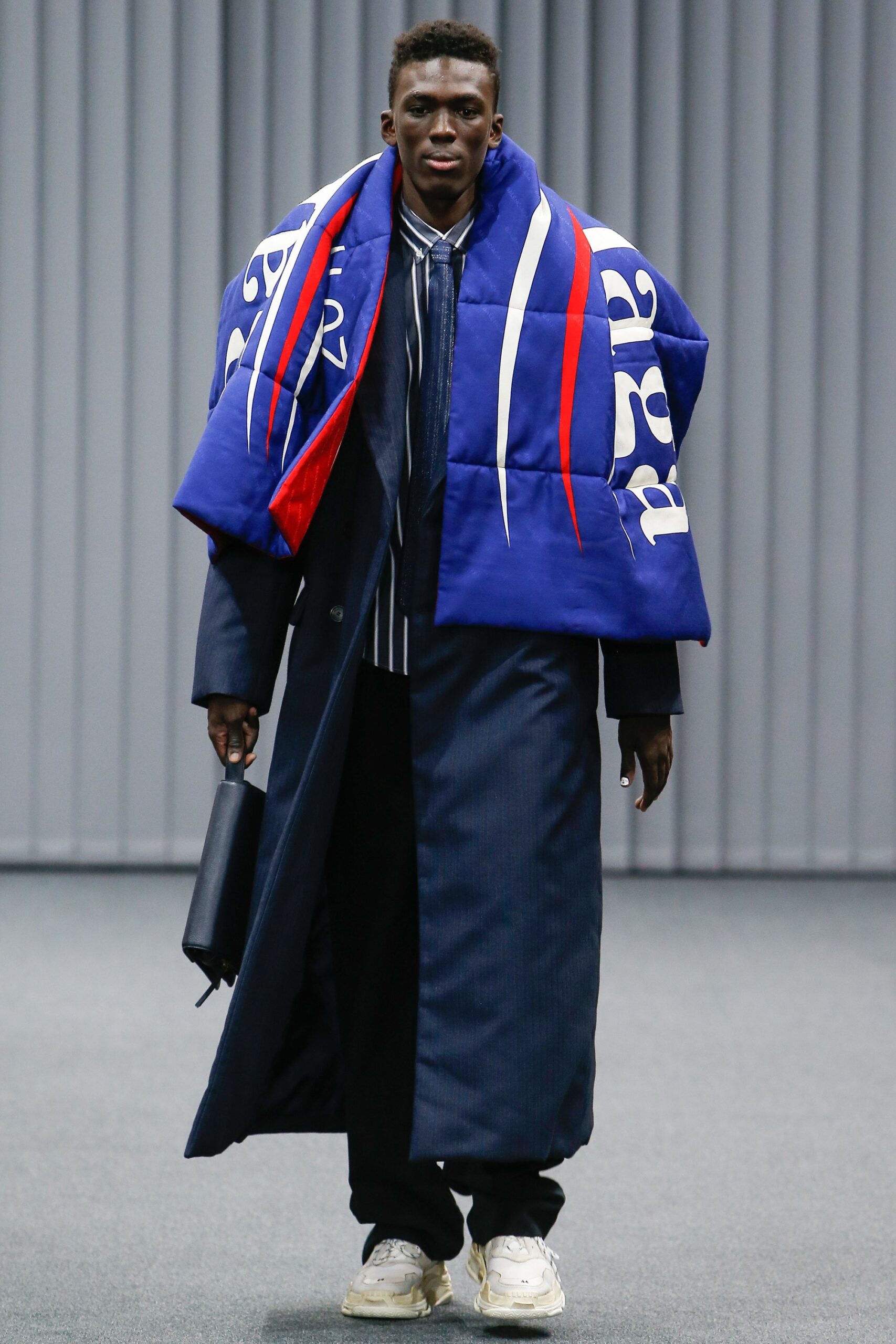 blue layered coat with striped shirt