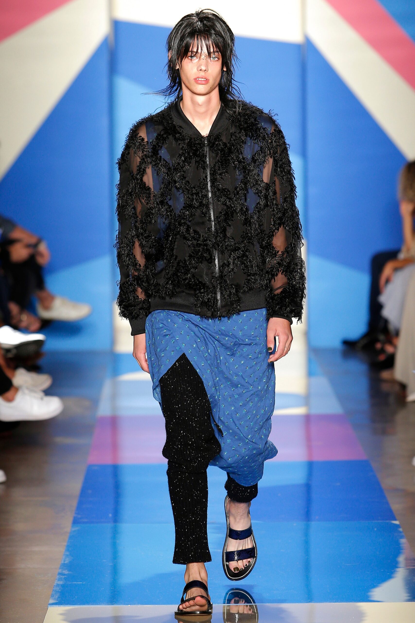 black fringed jacket with blue pants