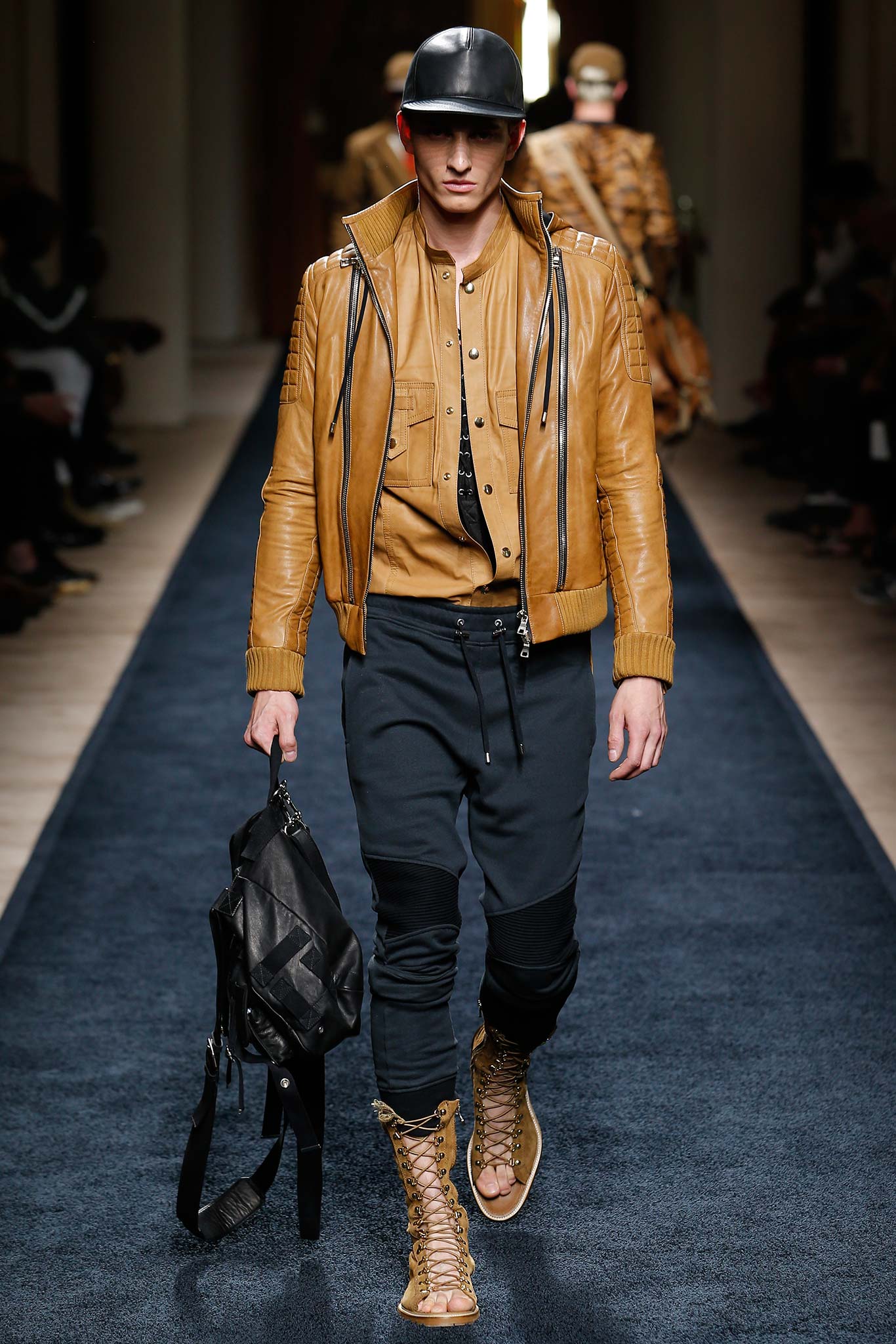 brown leather jacket with black pants