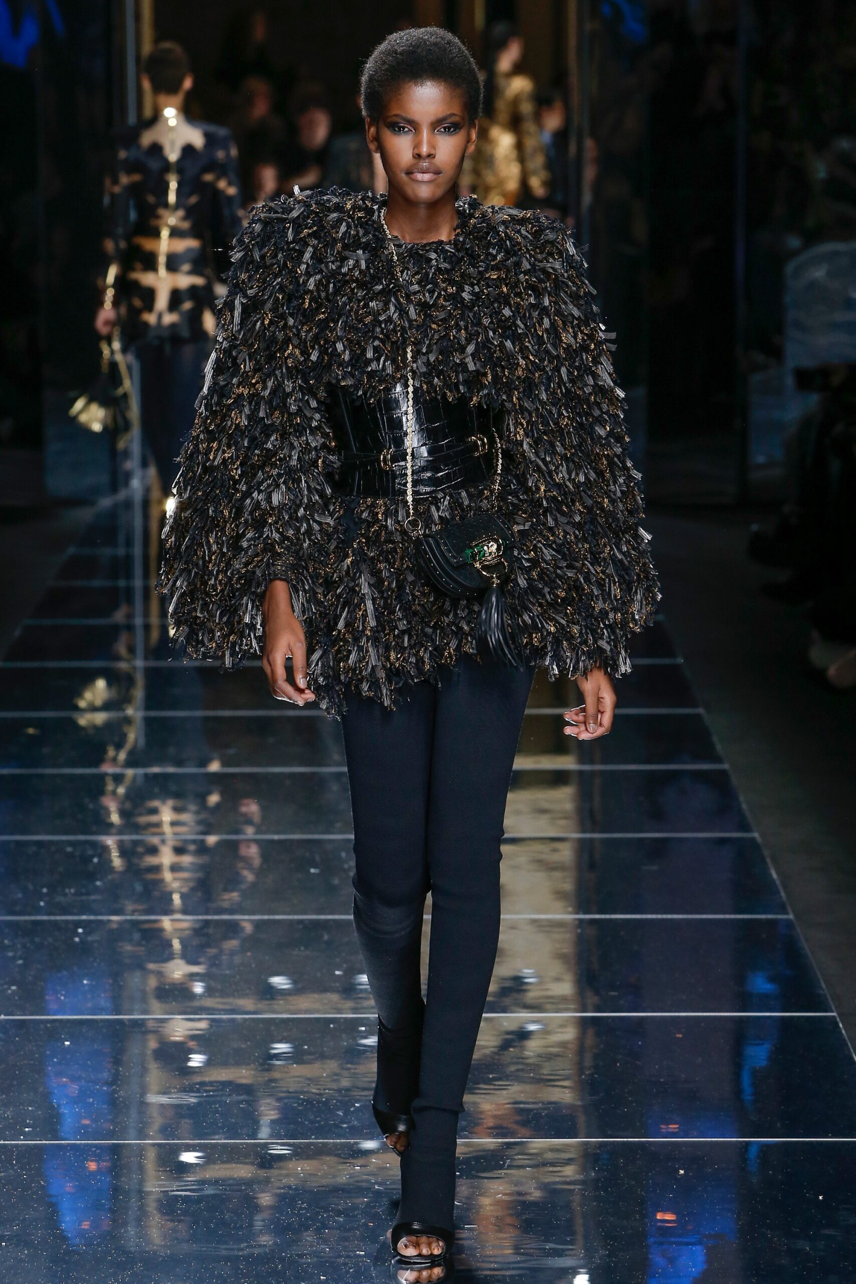 black and gold fringed top with slim pants