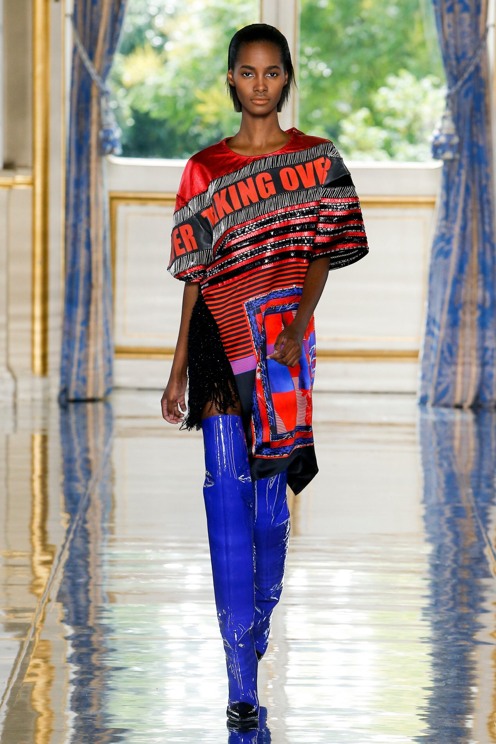 red embroidered top with blue pants