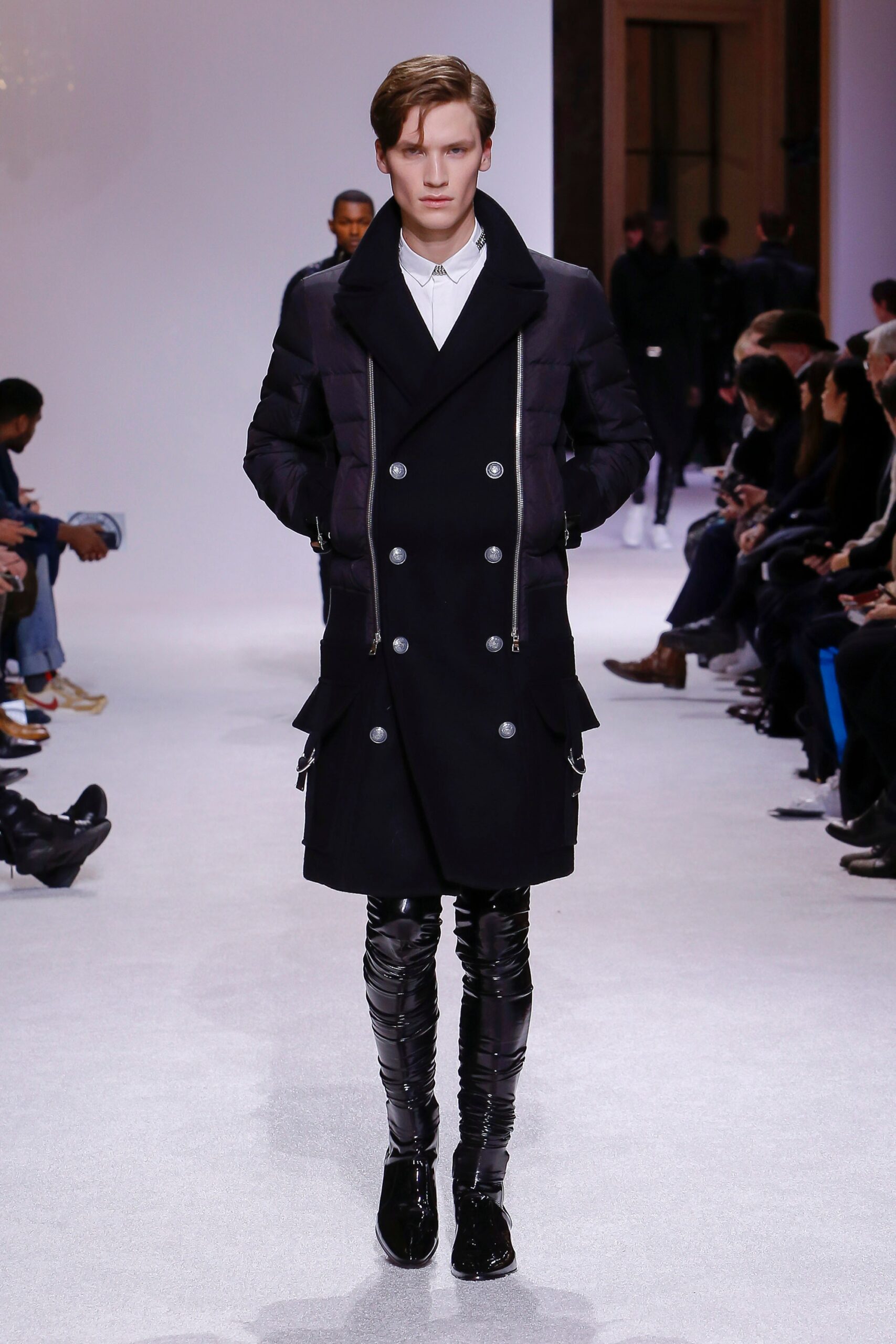 black fitted coat and vinyl pants