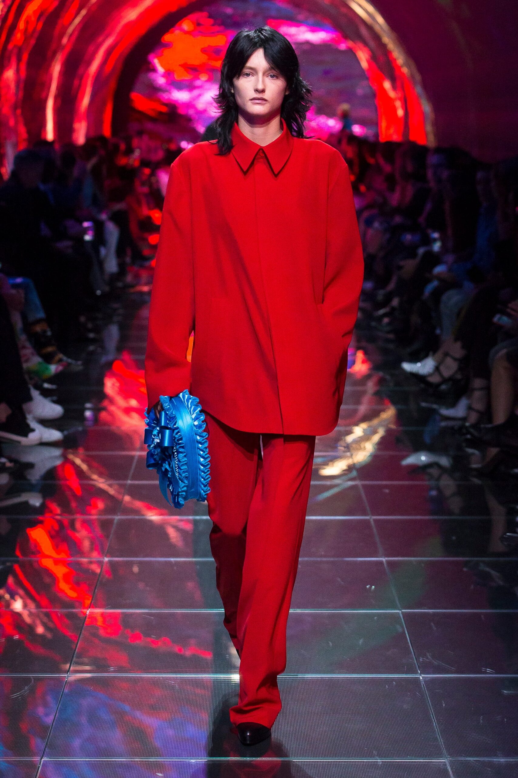 red relaxed suit with blue bag