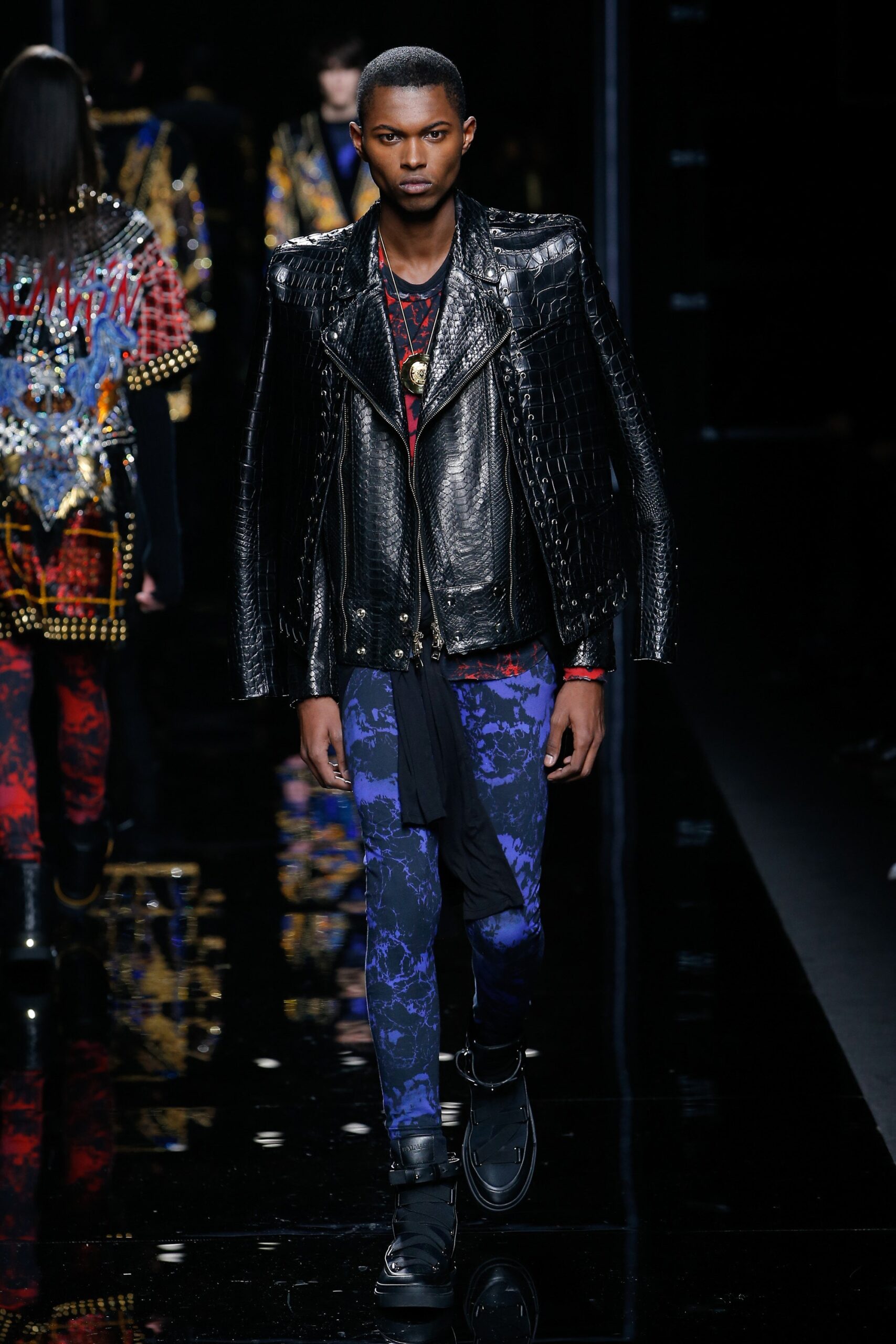 black leather fitted jacket and blue slim pants