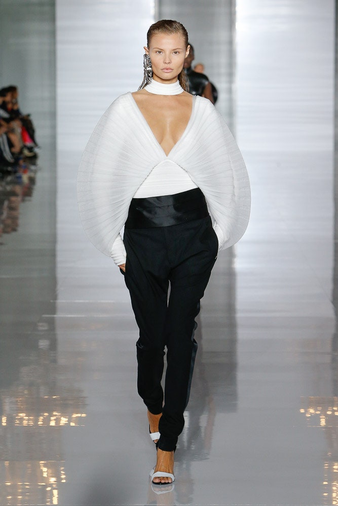 white draped top with black tailored pants
