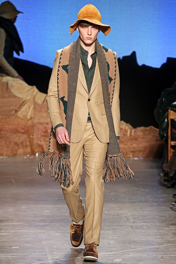 beige tailored suit with green shirt
