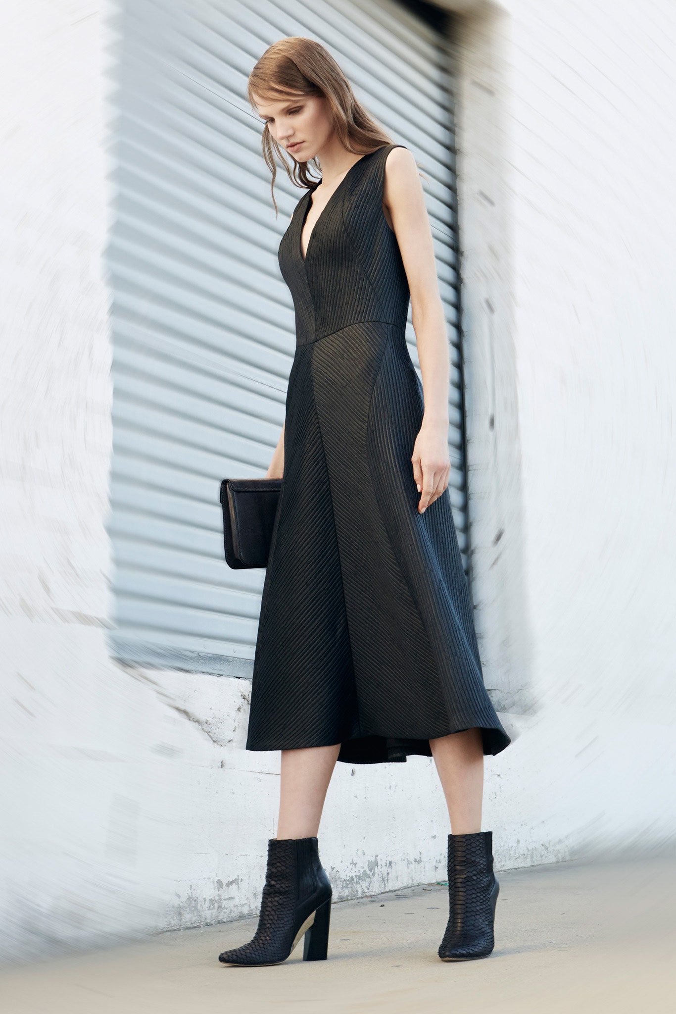 black leather sleeveless dress and boots