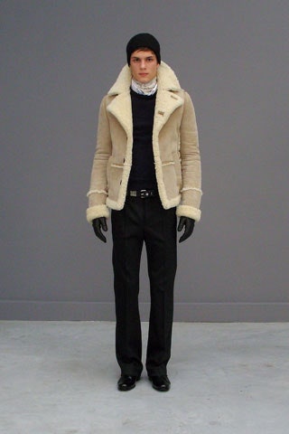 beige faux-fur jacket with black sweater