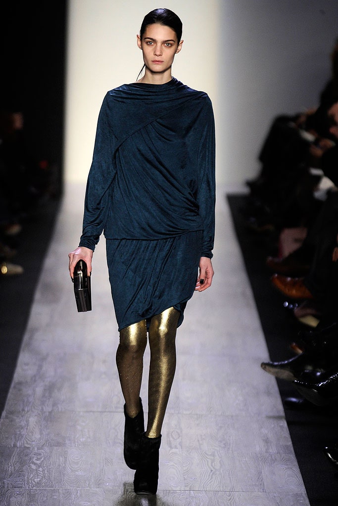 blue draped mini dress with gold leggings