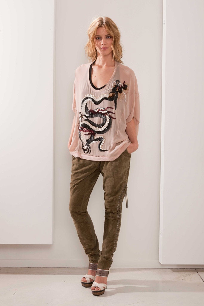 pink embroidered top with green pants