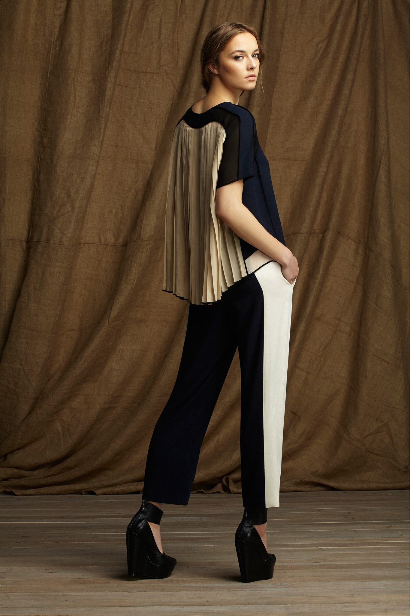 blue silk pleated top with black pants