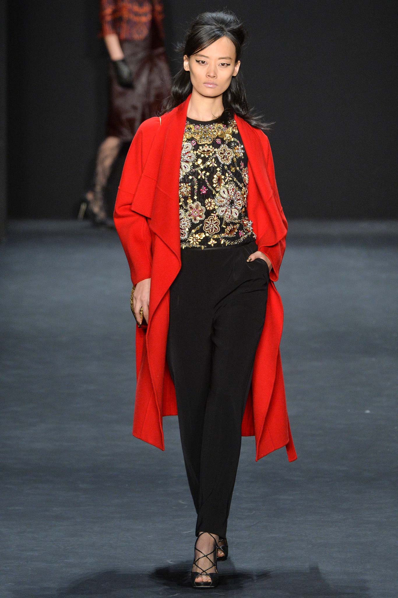 red coat black embroidered top black pants
