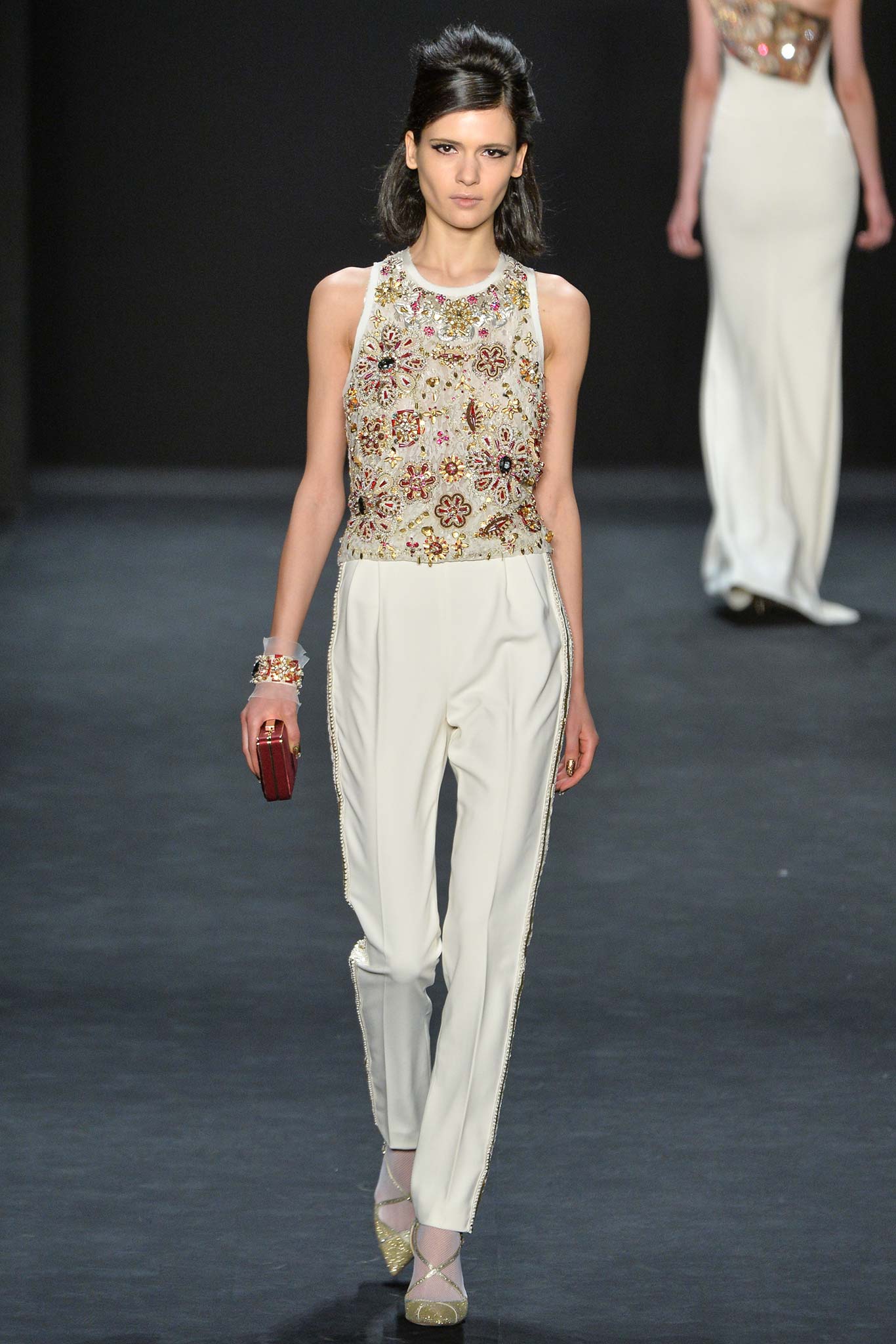 beige embroidered sleeveless top and white tailored pants
