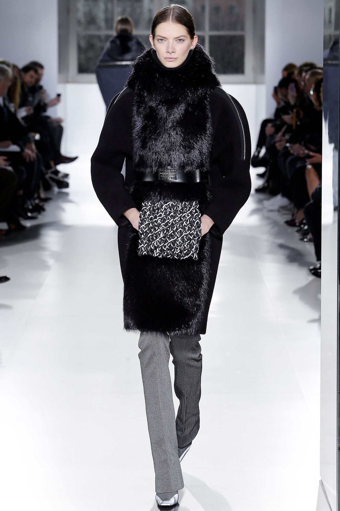 black faux-fur coat with gray pants