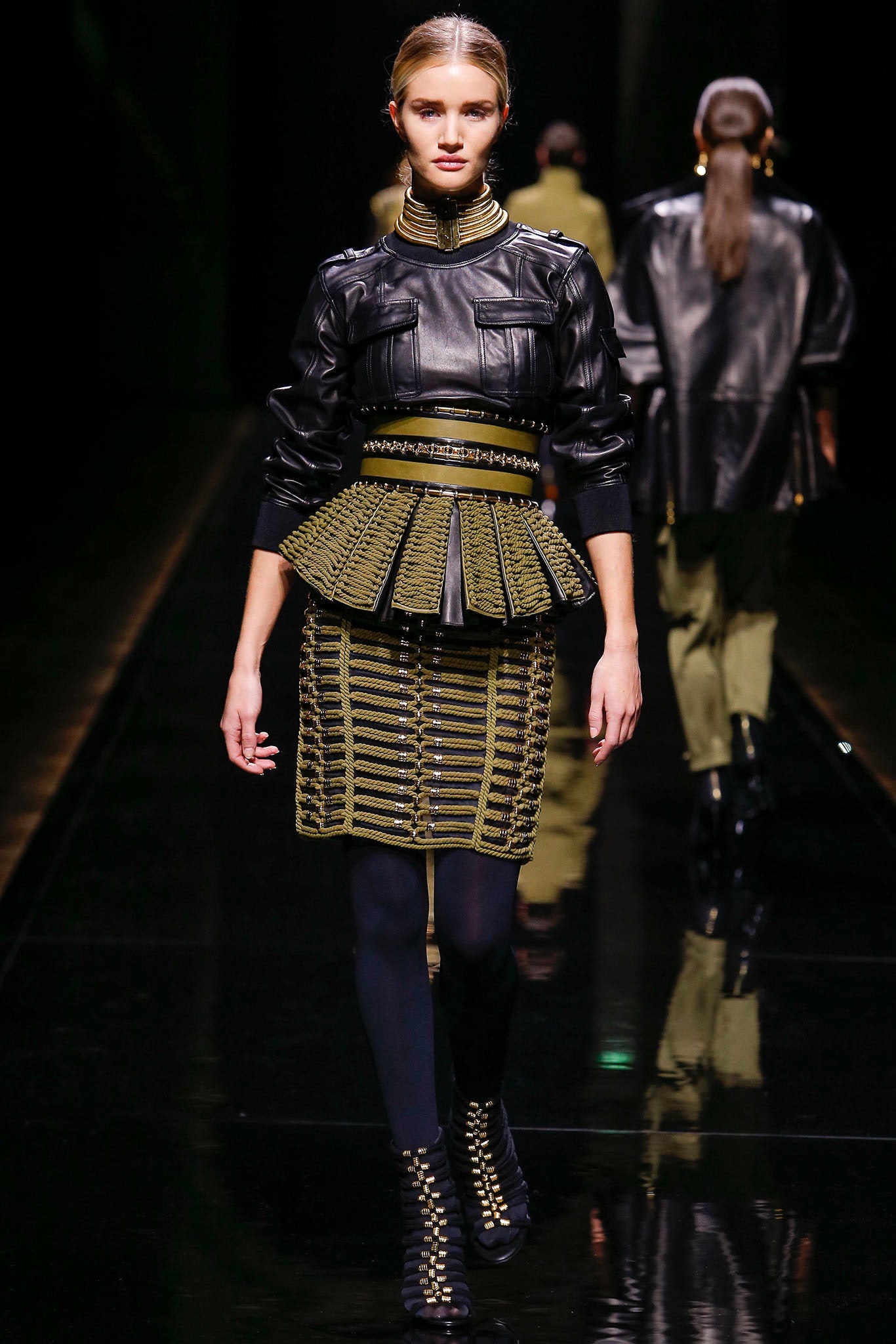 black leather fitted top and green pleated skirt