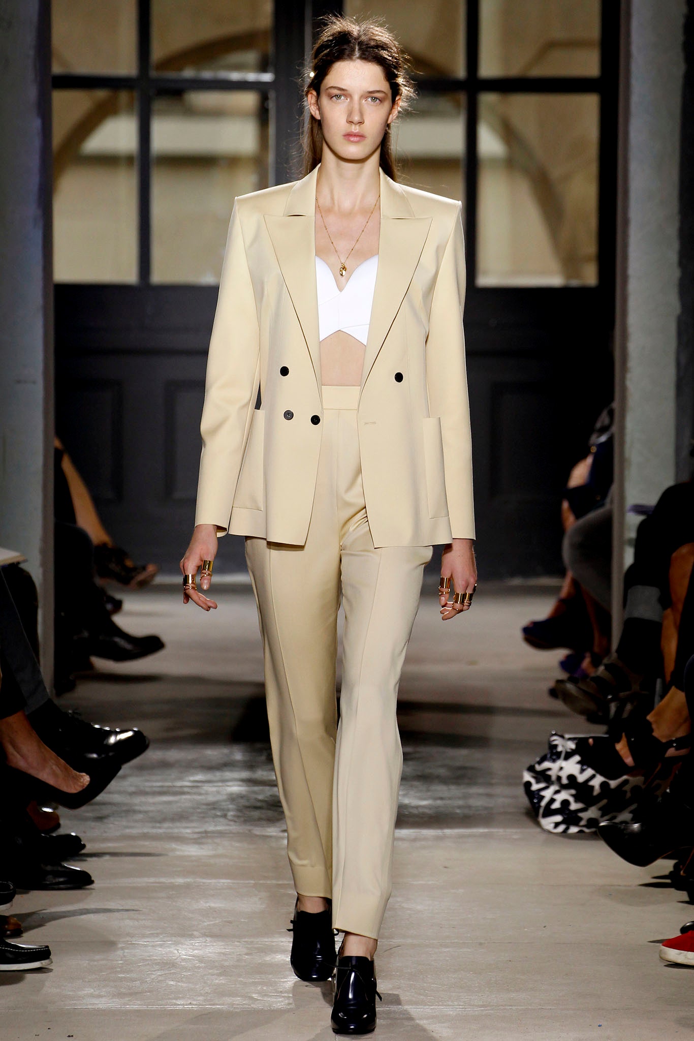 beige tailored suit with white bra