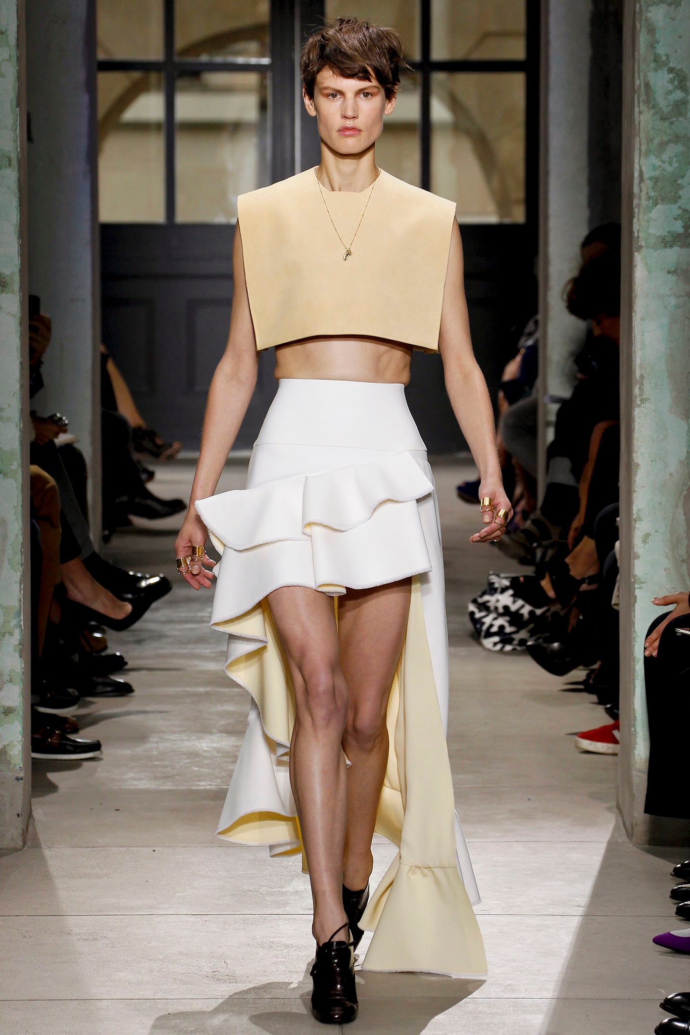 beige leather fitted top and white ruffled skirt