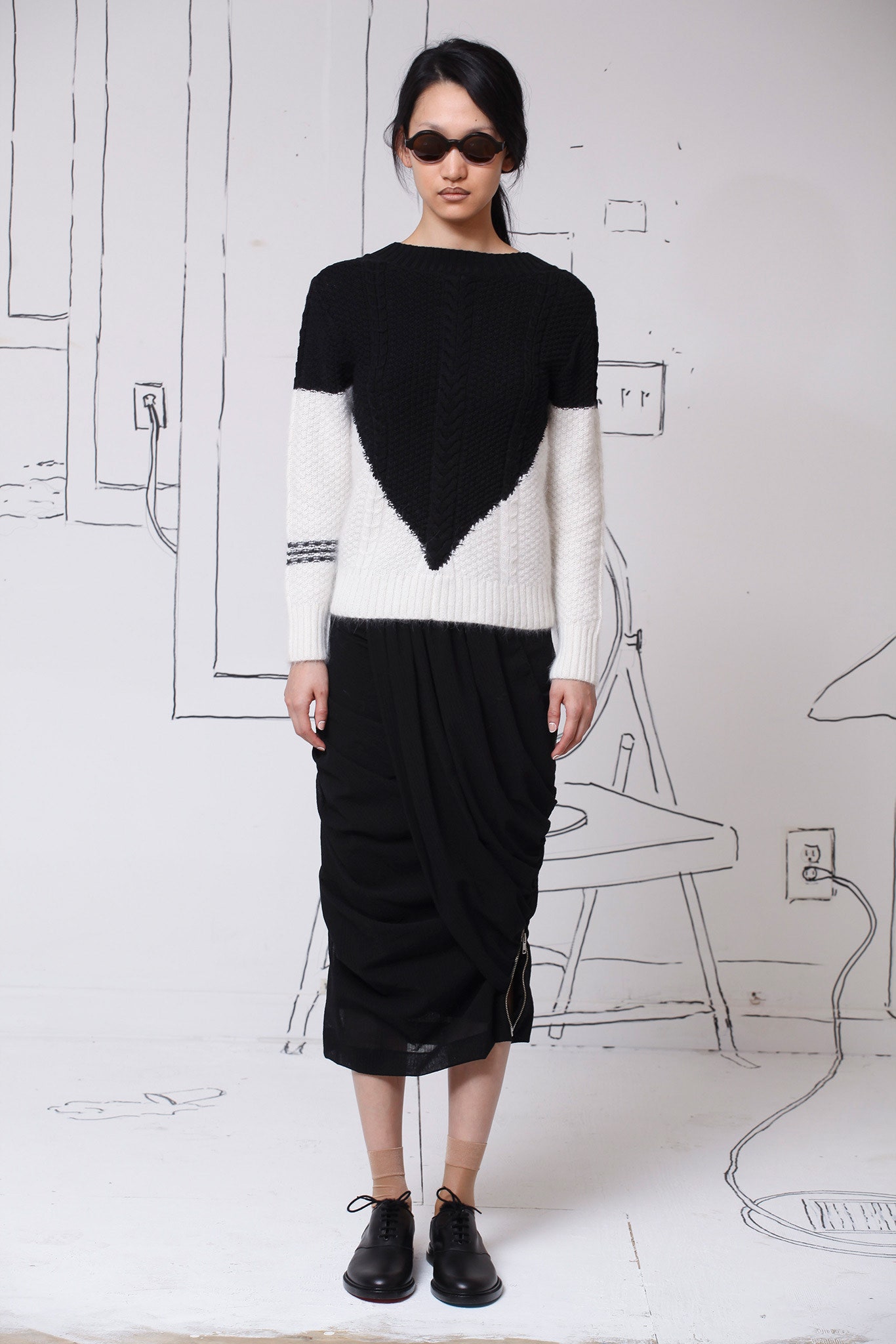 black and white fitted sweater with draped skirt