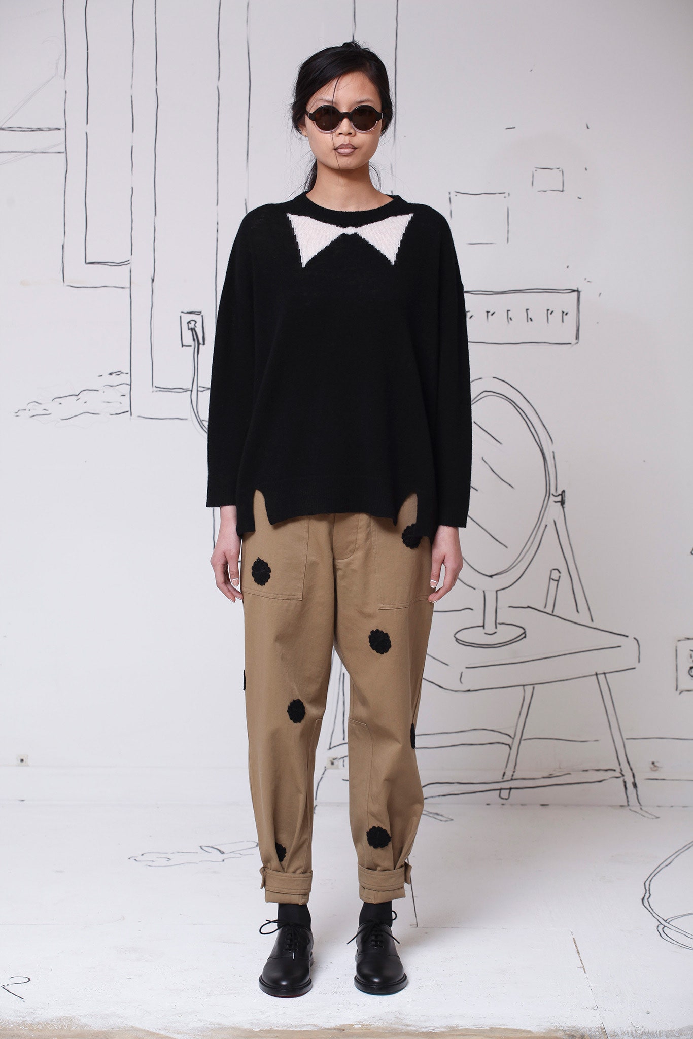 black oversized sweater with beige pants