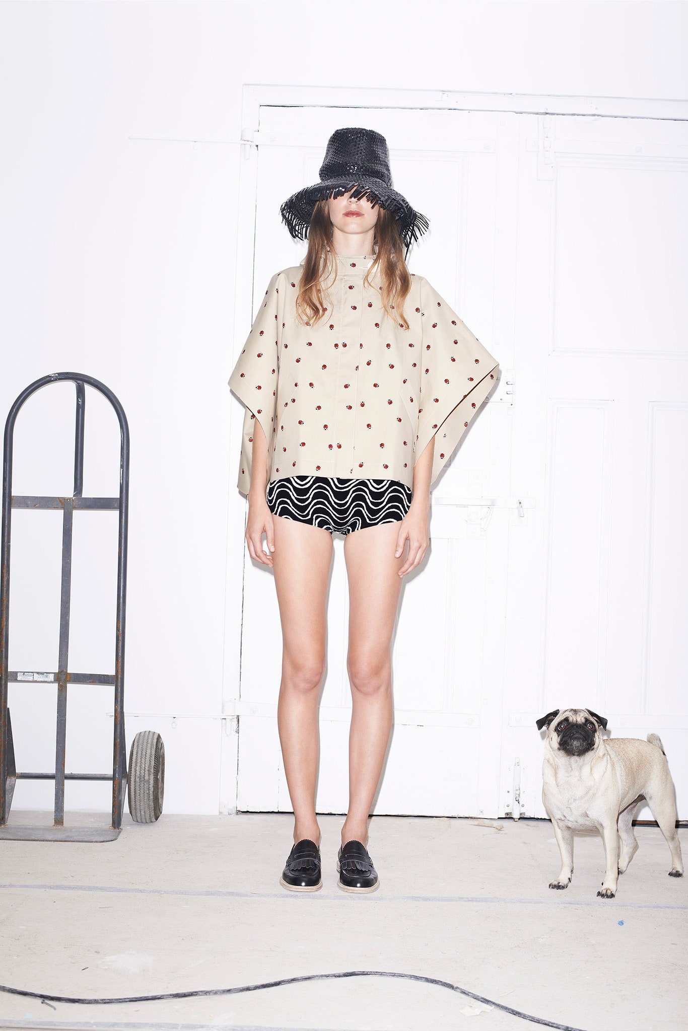 beige polka-dot poncho with black shorts