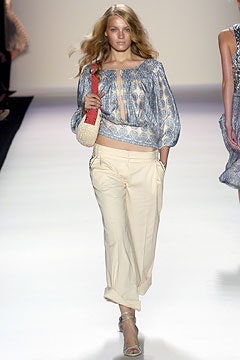 blue embroidered off-shoulder top with beige pants