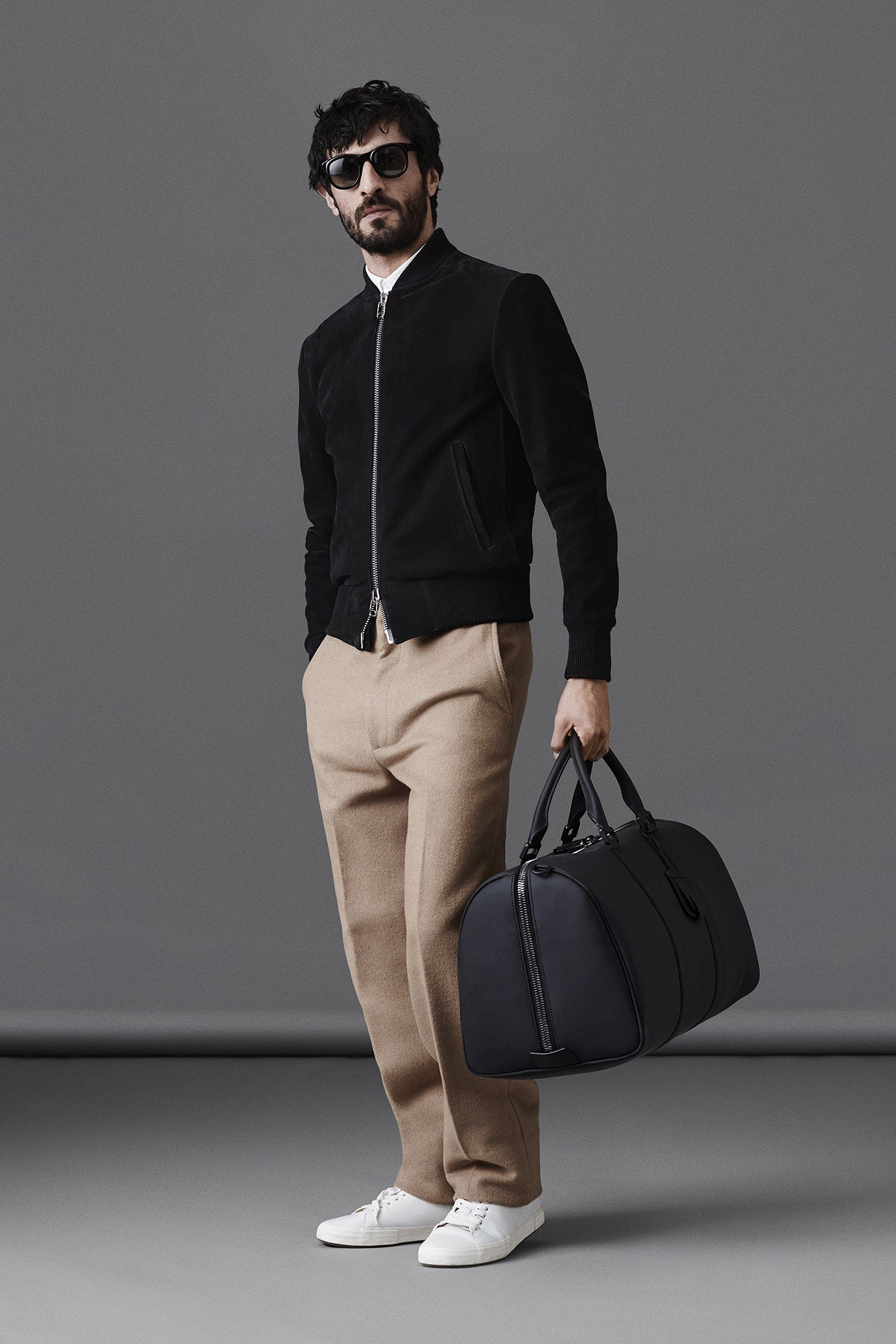 black suede jacket with beige pants