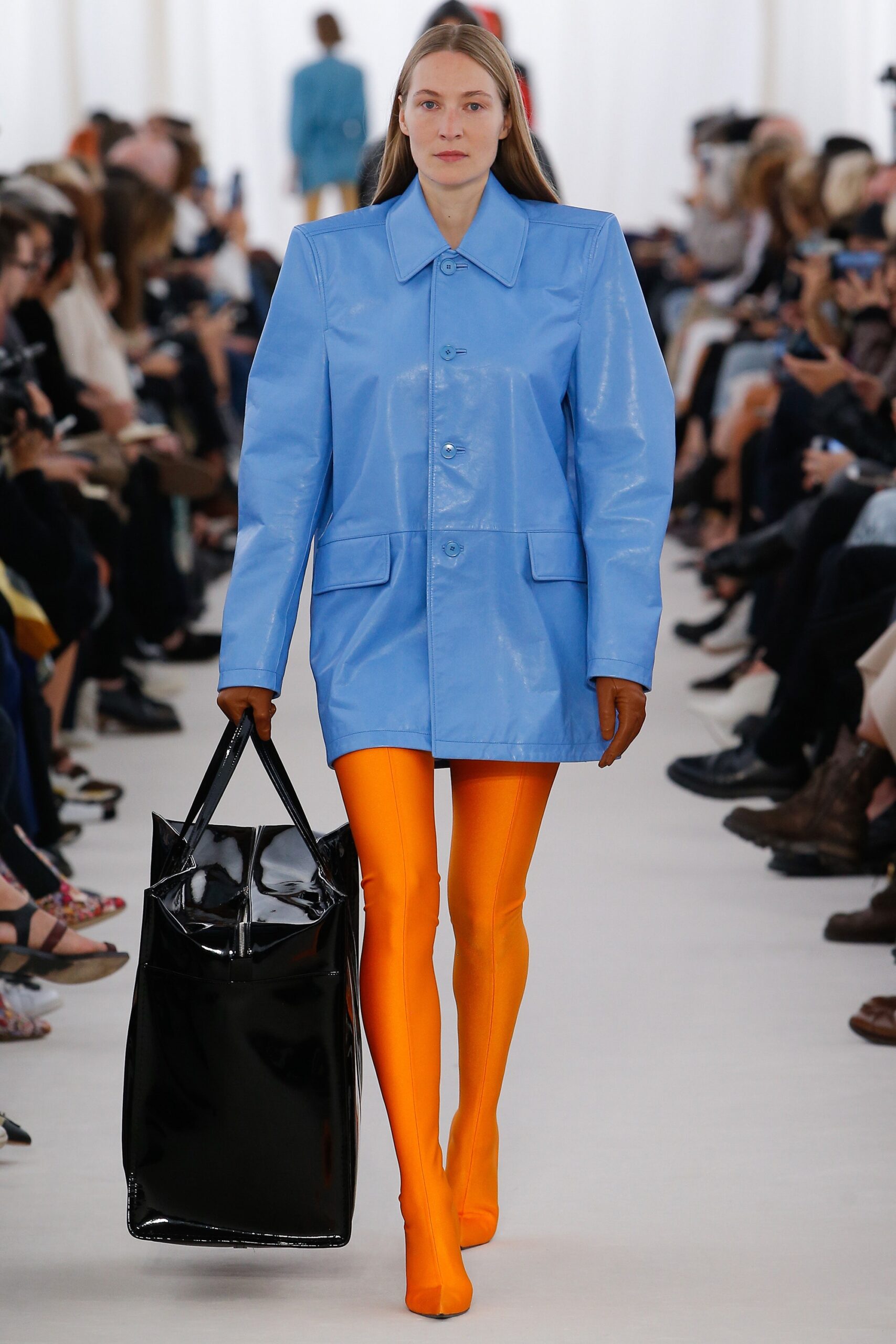 blue vinyl coat and orange pants