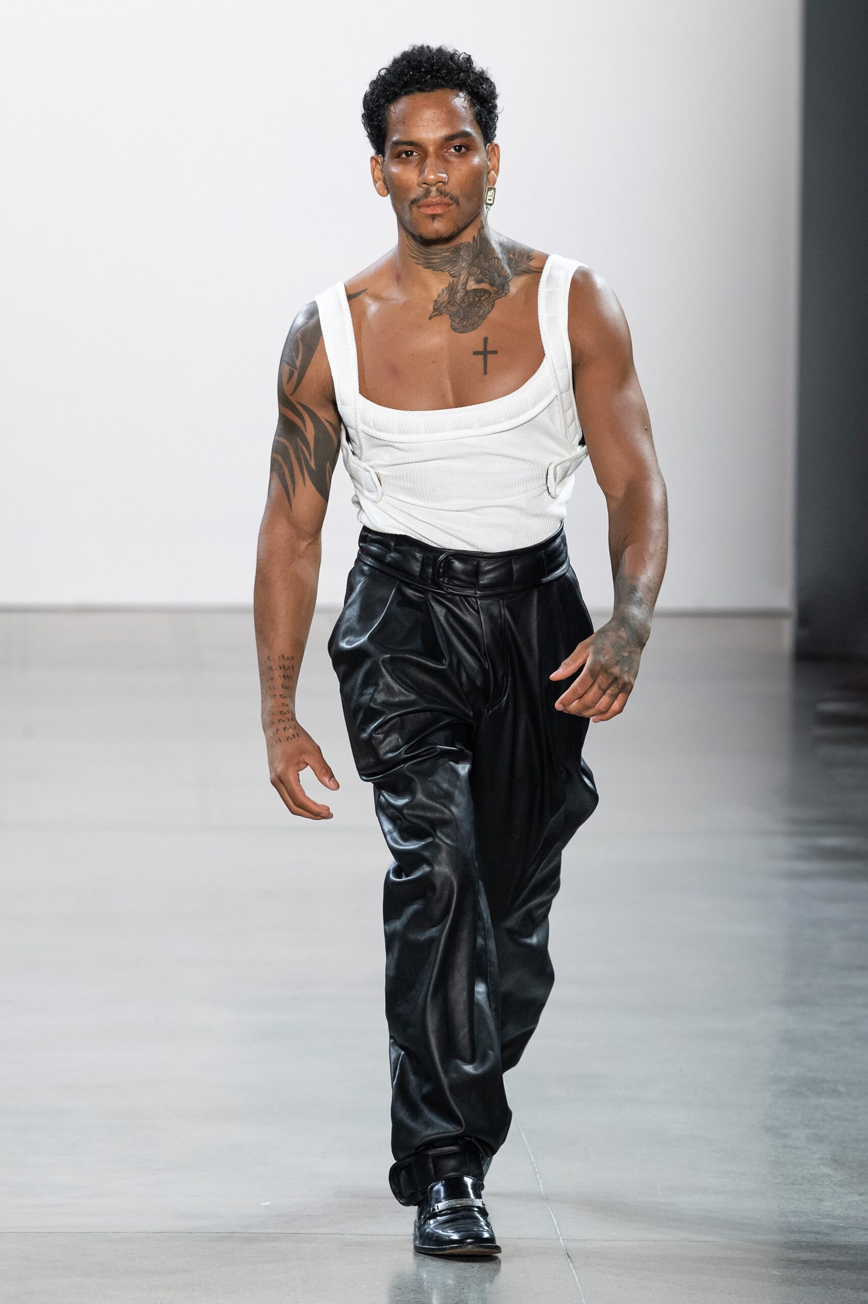 fitted white sleeveless top and relaxed black leather pants