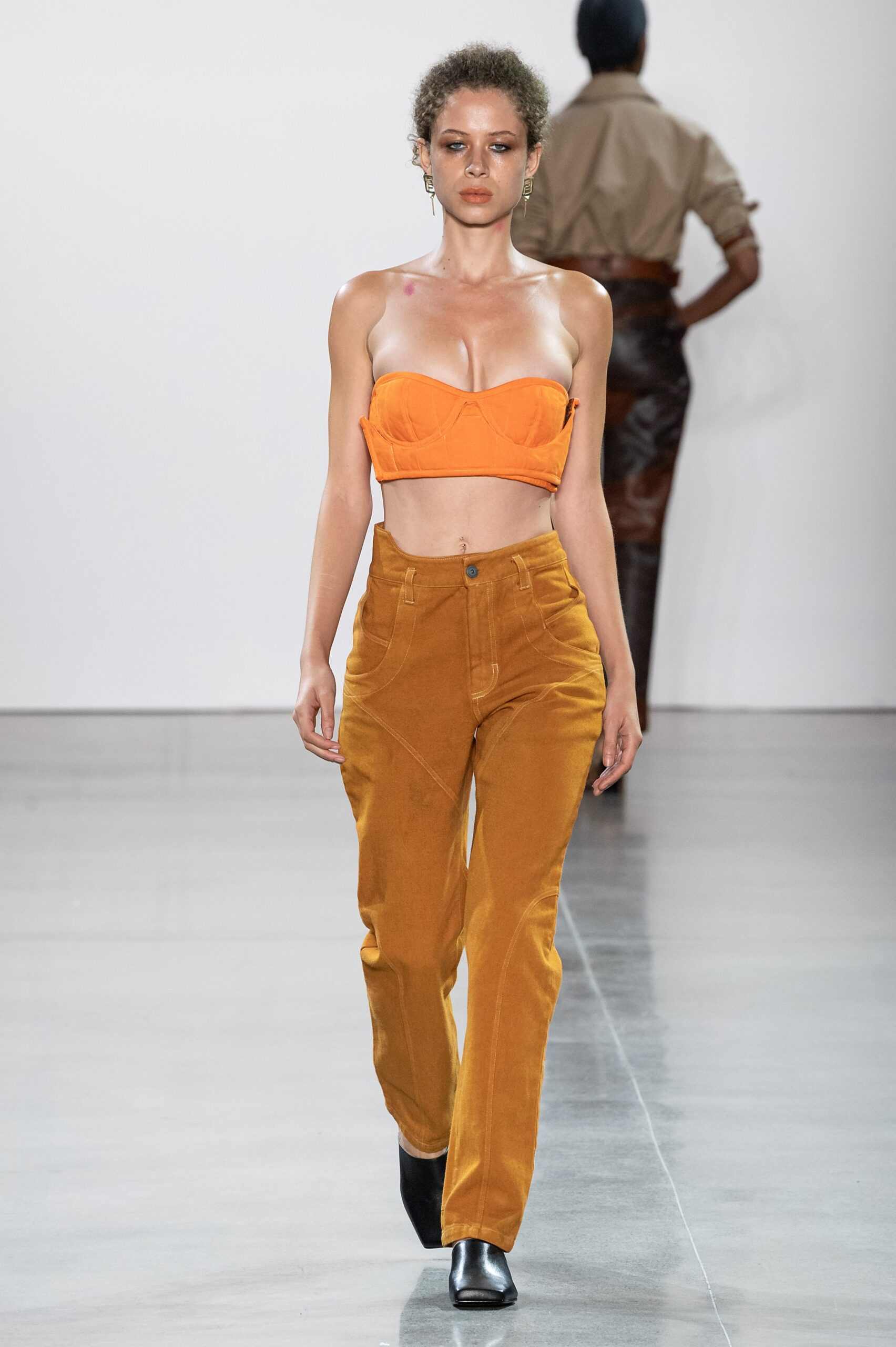 orange crop-top and brown pants