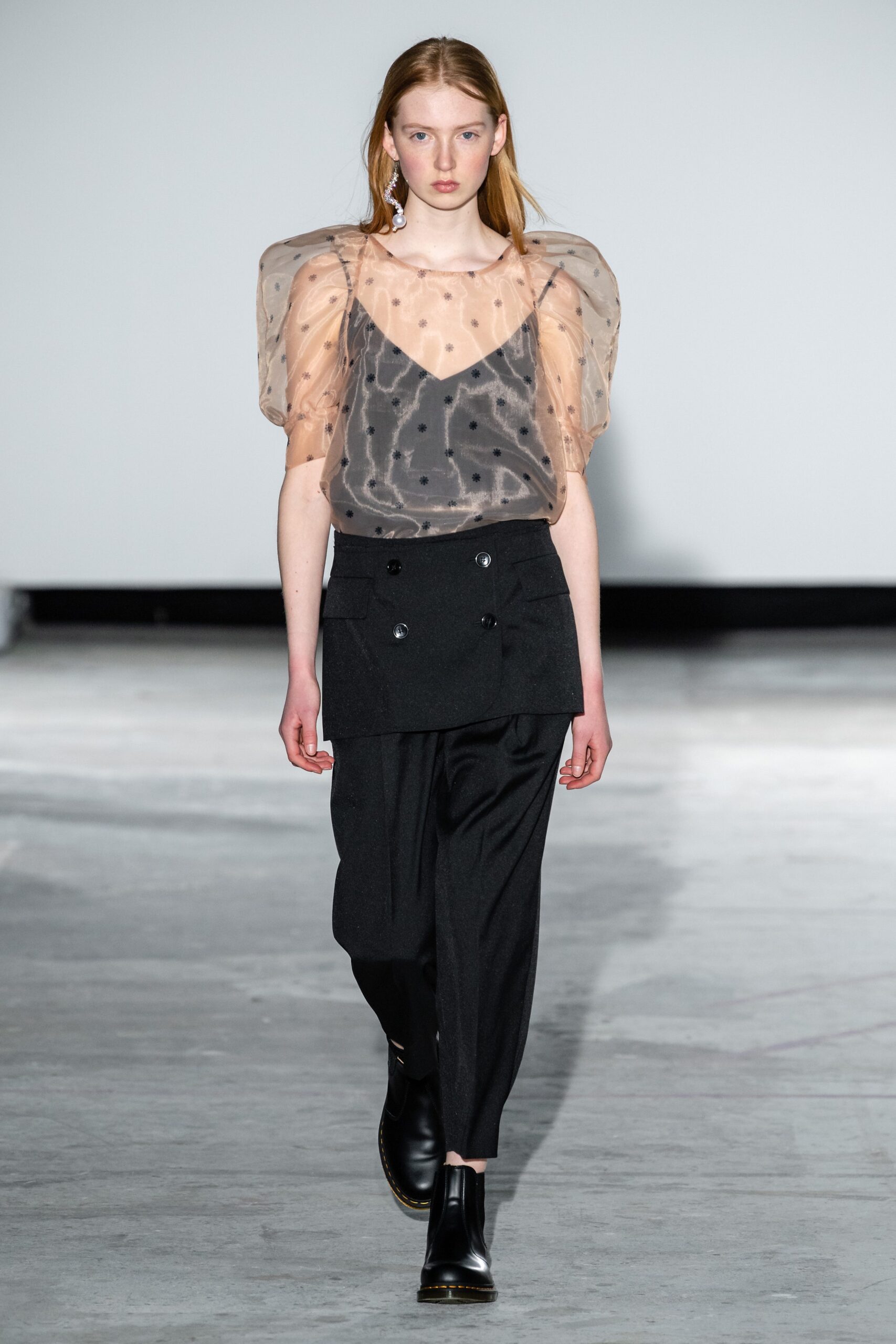 beige polka-dot sheer top with black pants