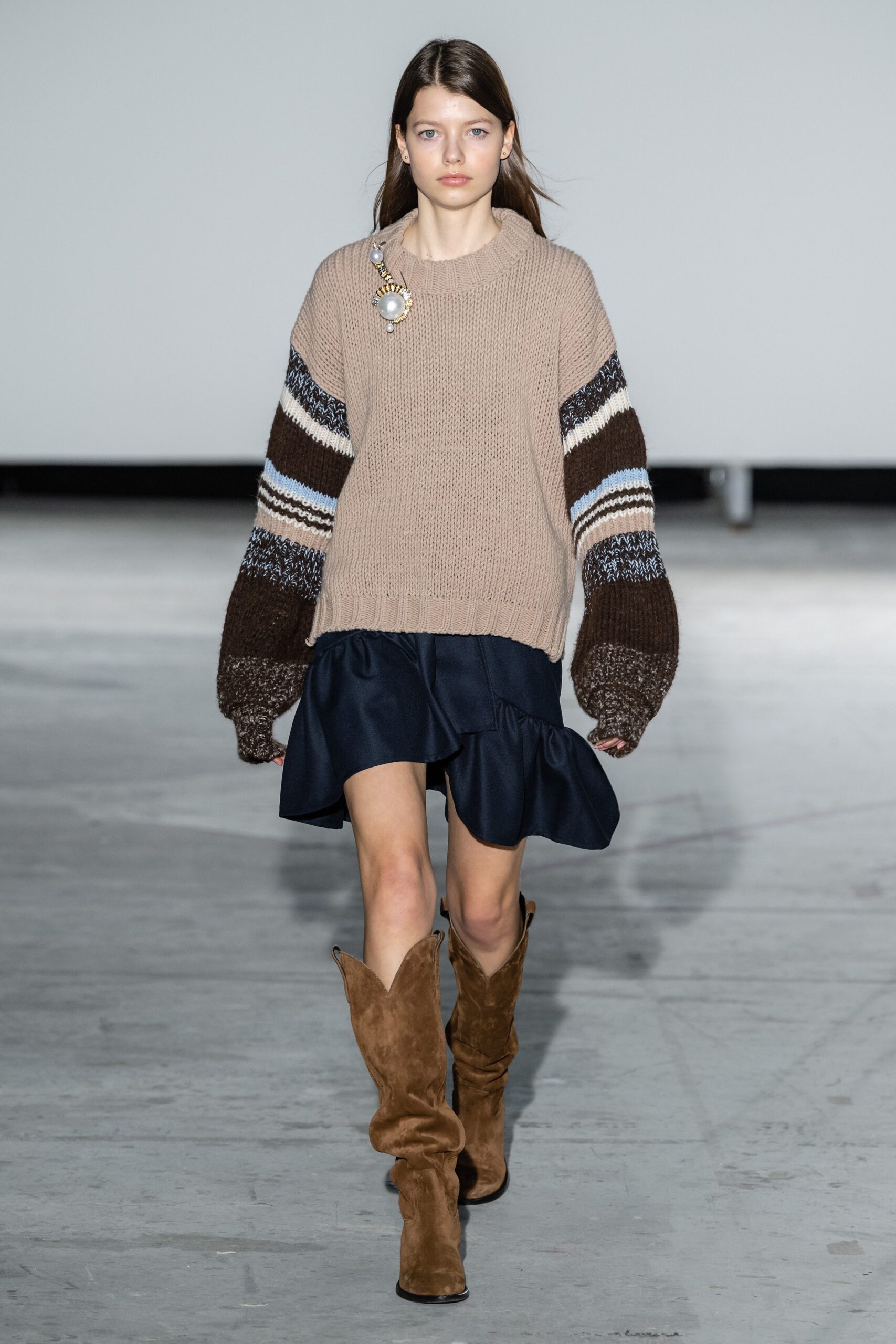 beige wool sweater with flared navy skirt