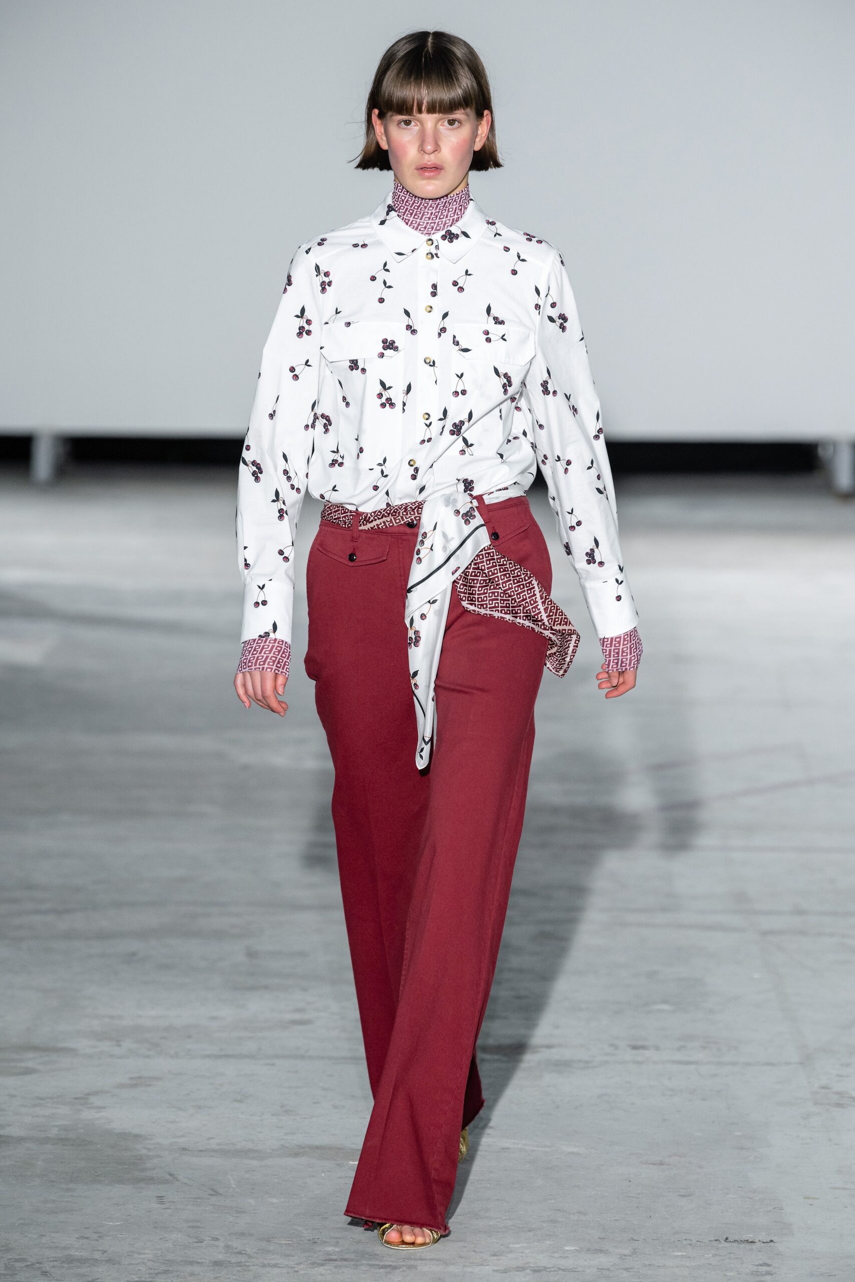 relaxed white printed shirt and tailored red pants