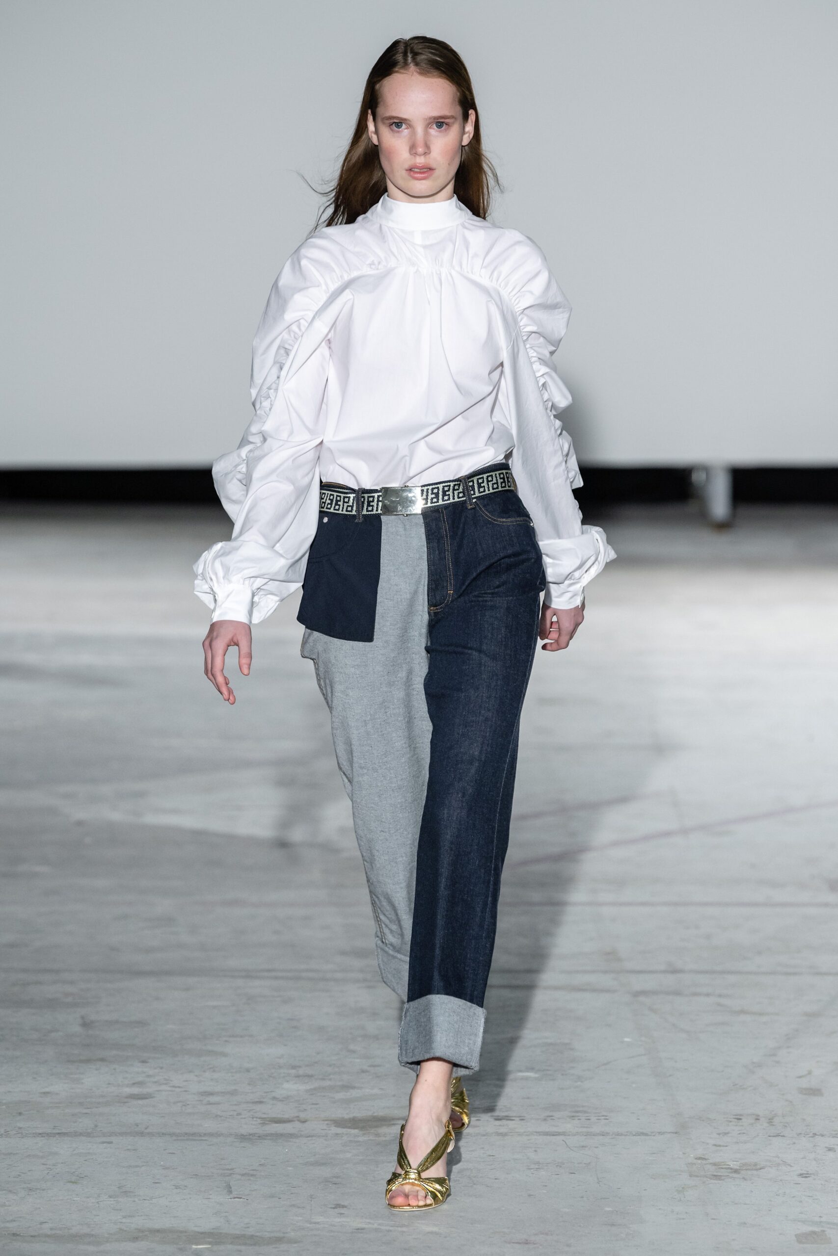 white ruffled blouse with color-blocked pants
