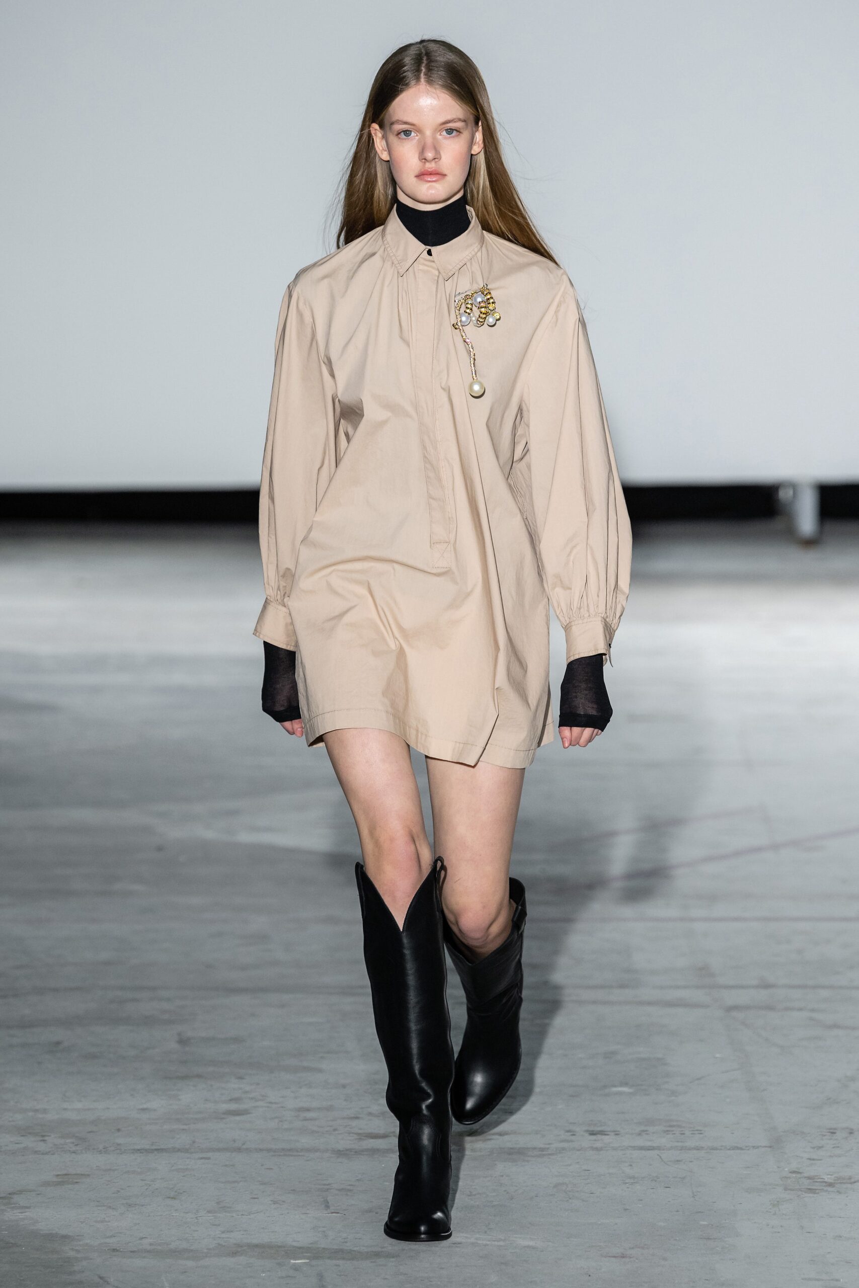beige shirt-dress with black boots